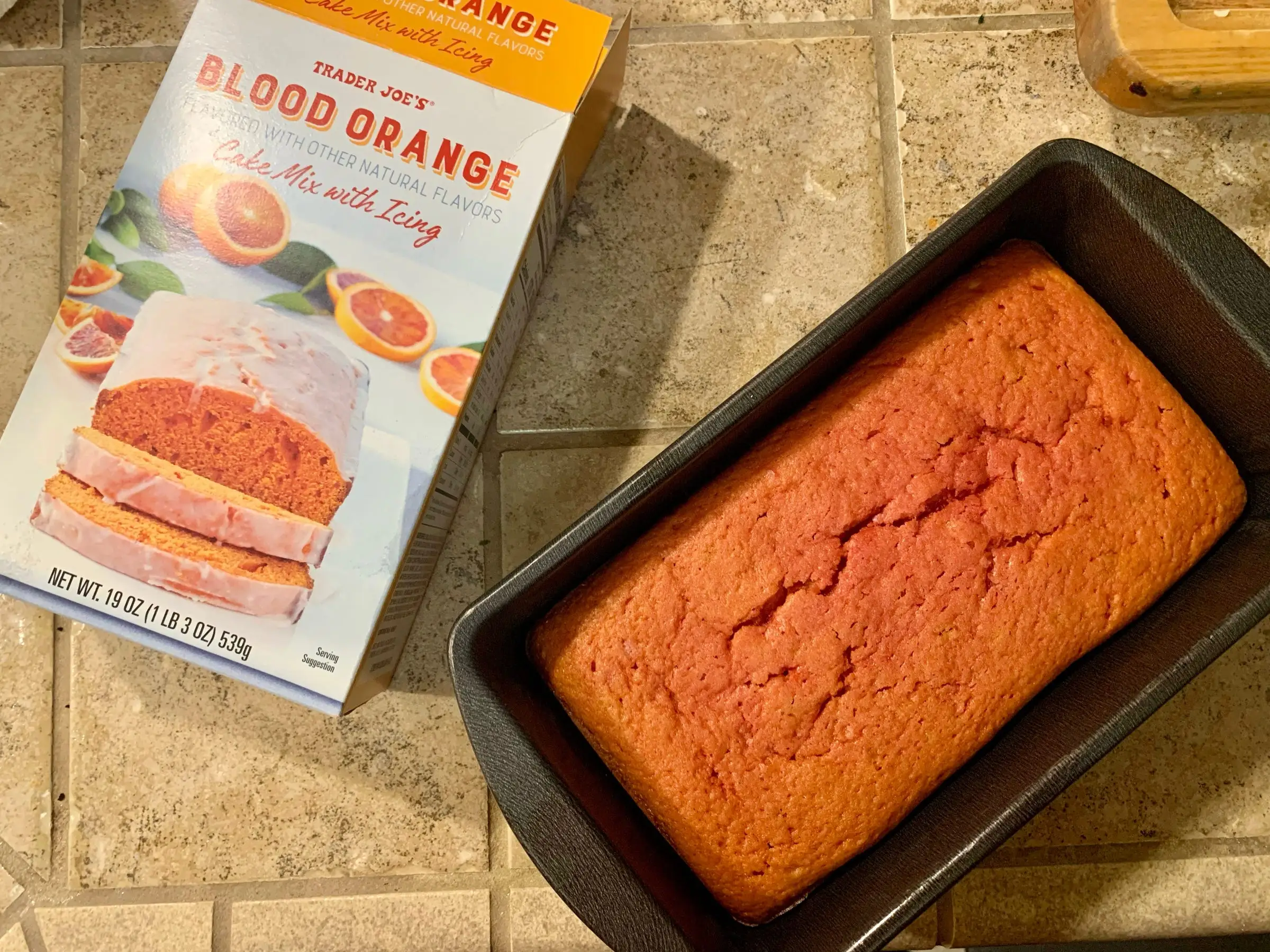A box of Trader Joe's blood-orange cake mix beside the cooked loaf cake.
