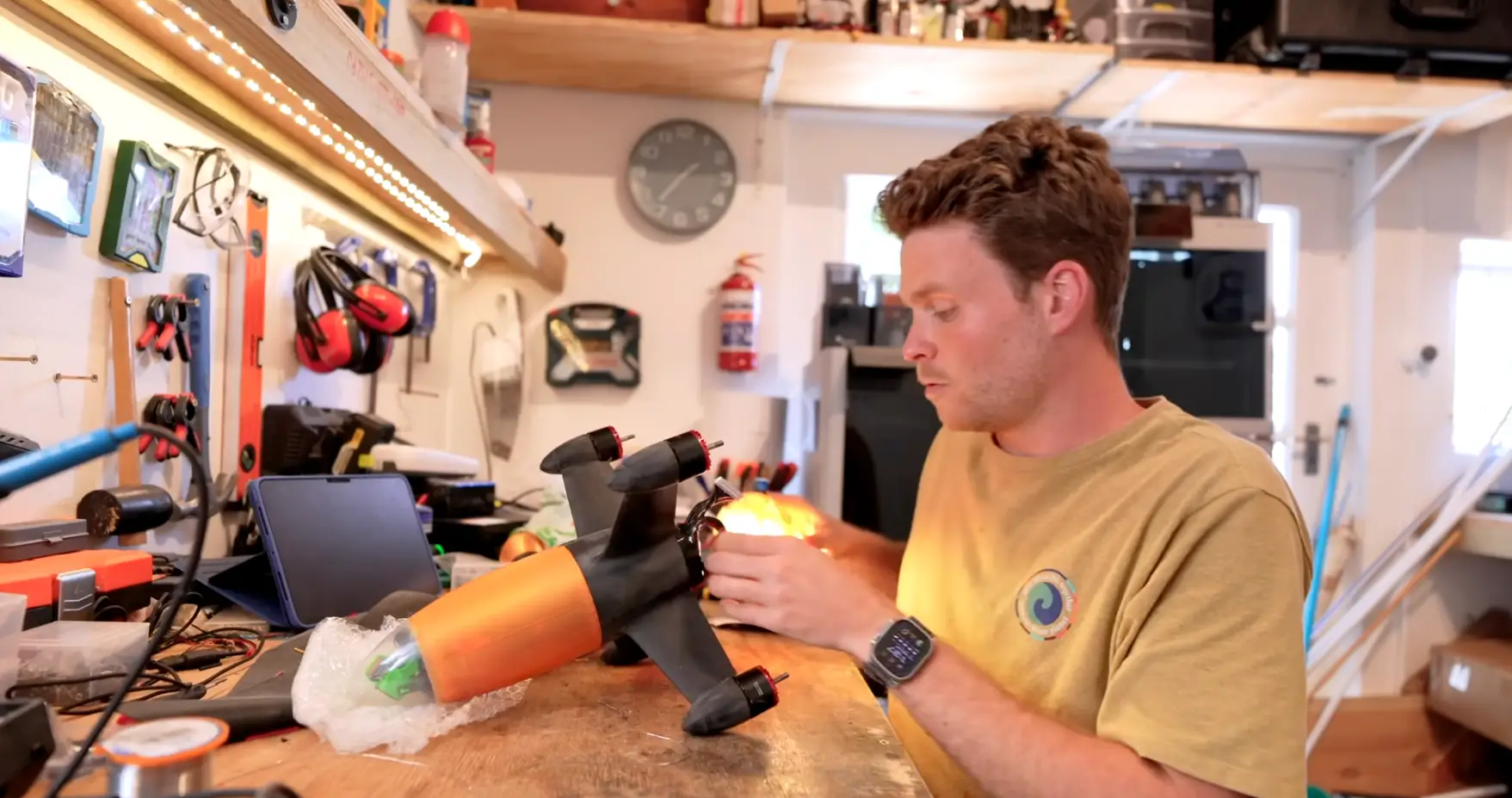 Bell tinkers with the Peregreen V4 in a workshop.