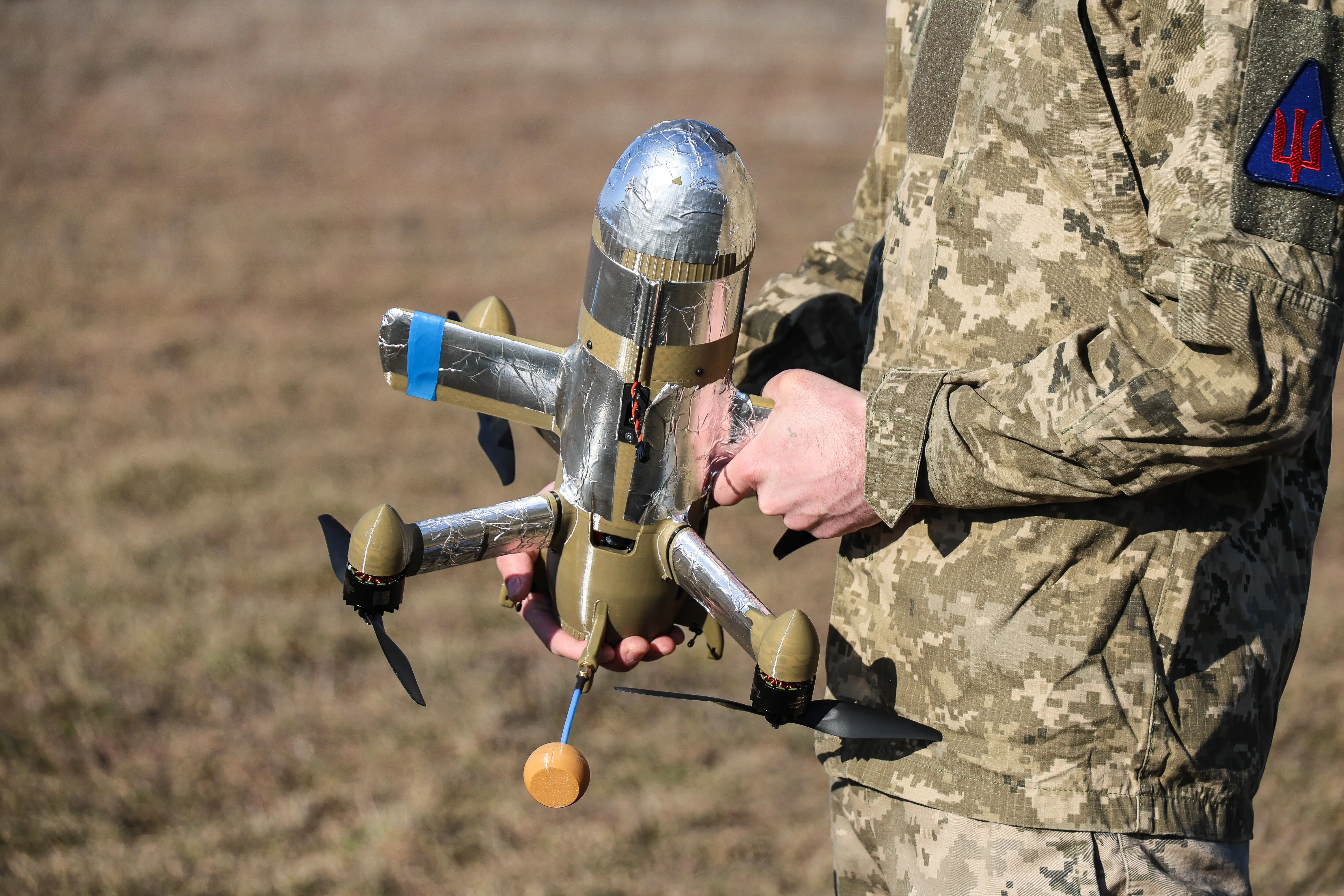 A soldier from the Khanter (Hunter) group of Ukraine's 208th Khersonska Anti-Aircraft Missile Brigade holds an interceptor drone.