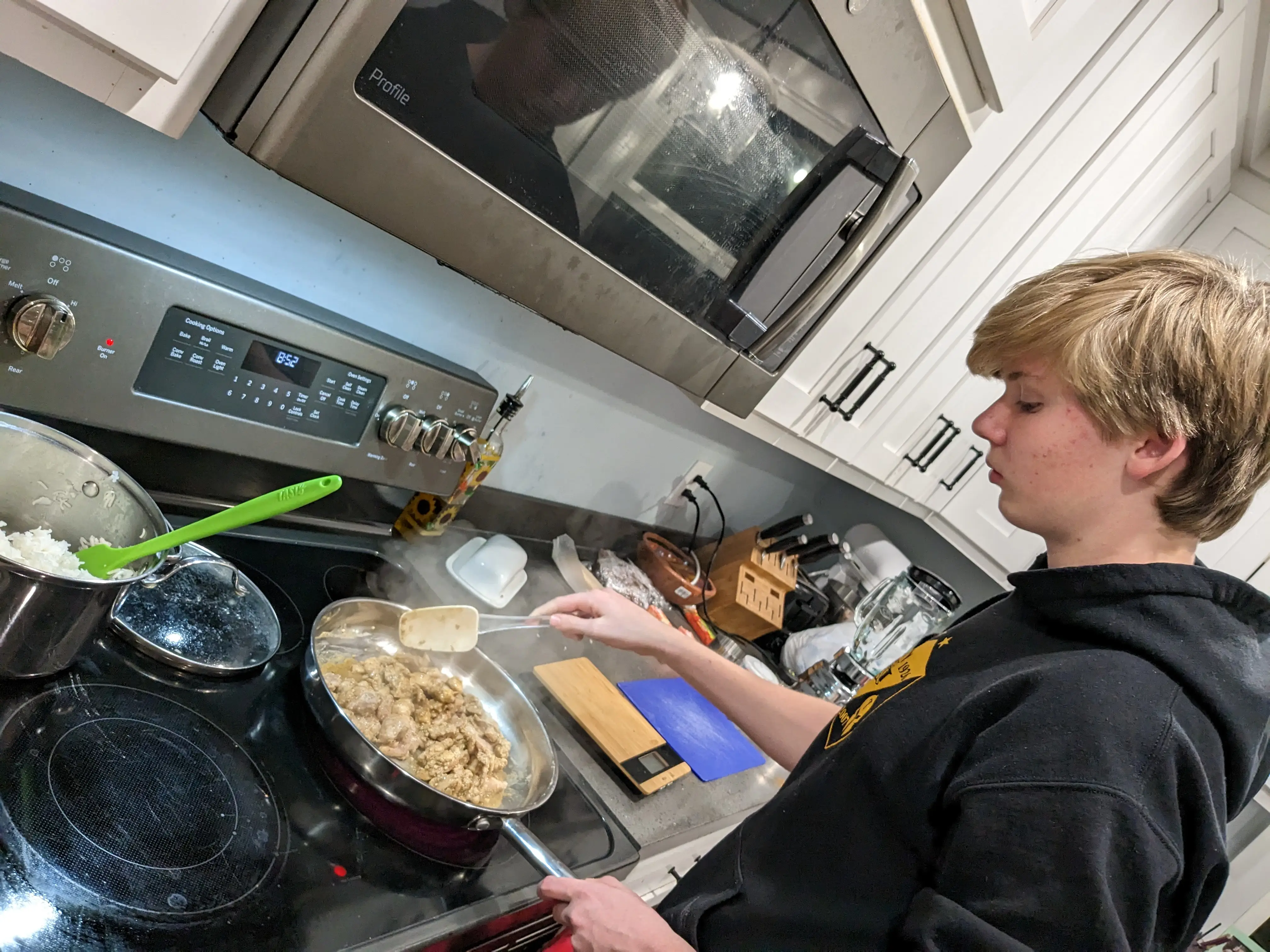 The author;s son helps to cook a meal for the family.