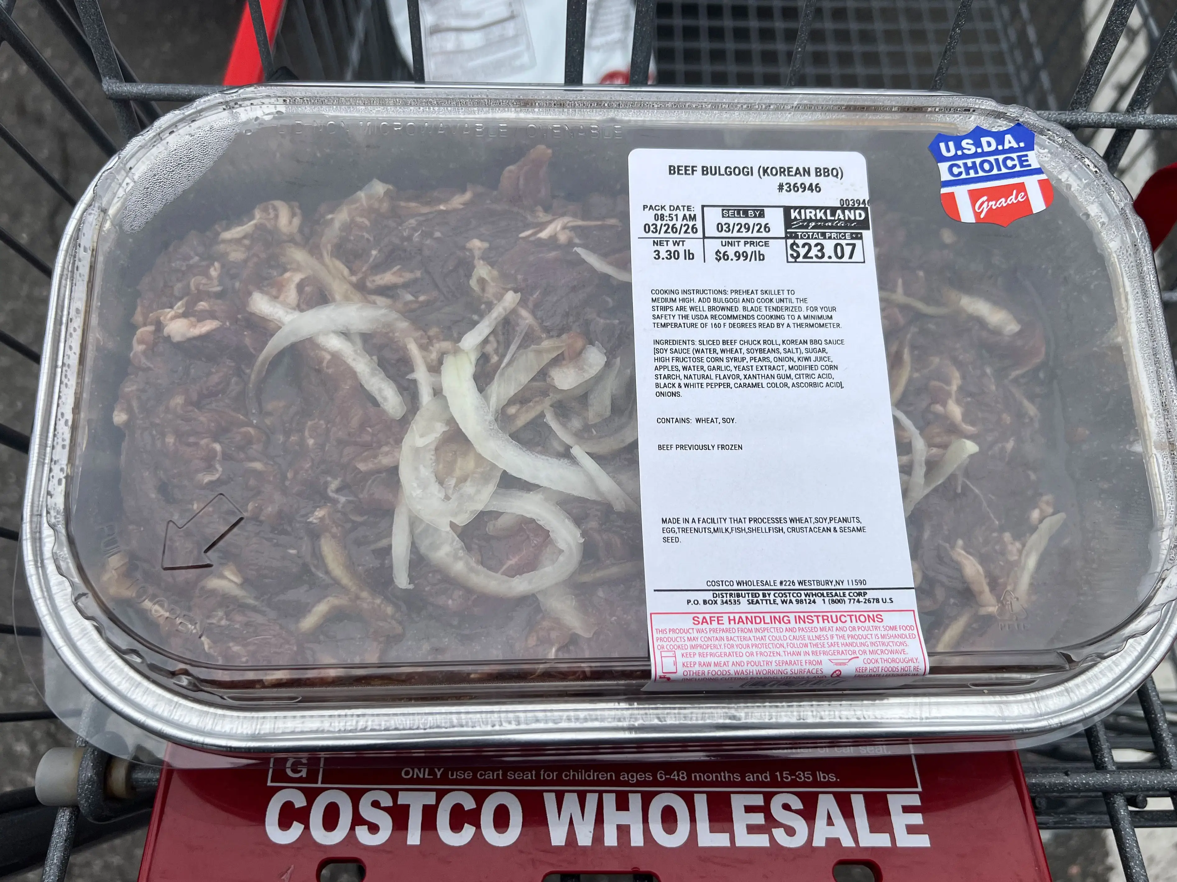 A container of Kirkland Signature beef bulgogi in a Costco shopping cart.