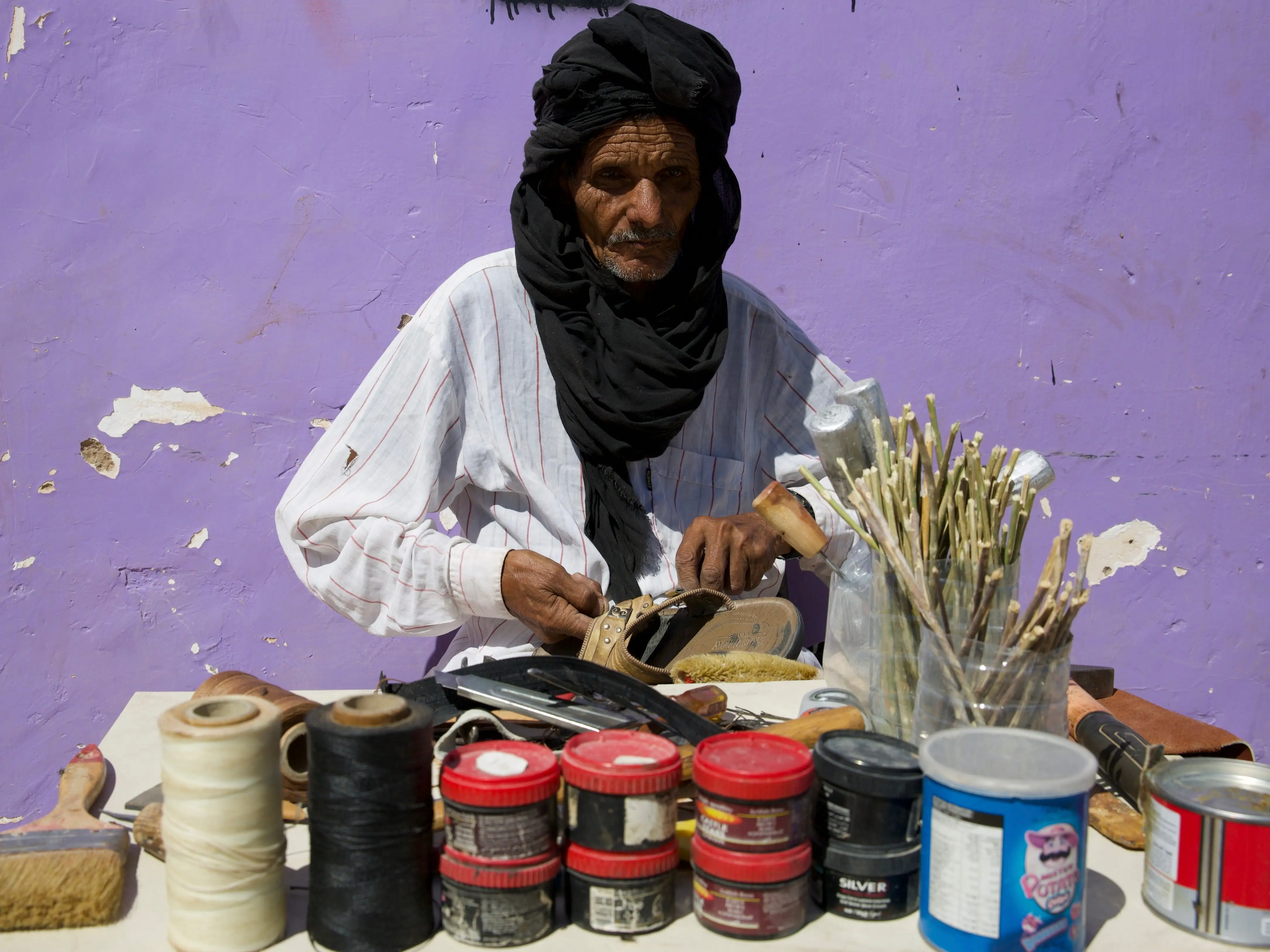 A man works on footwear in the Boujdour Camp, Tindouf, Algeria.