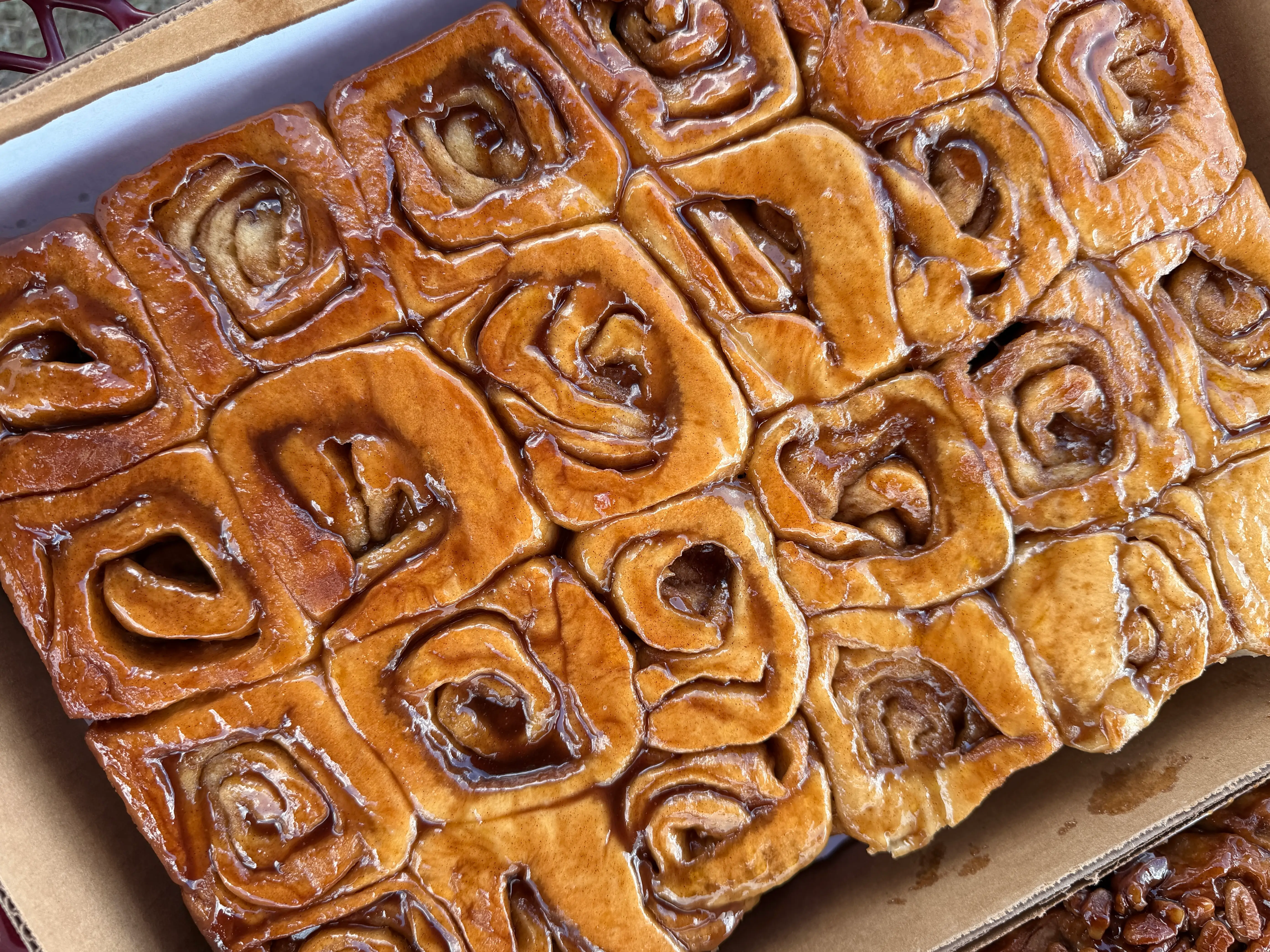 A box of large cinnamon rolls.