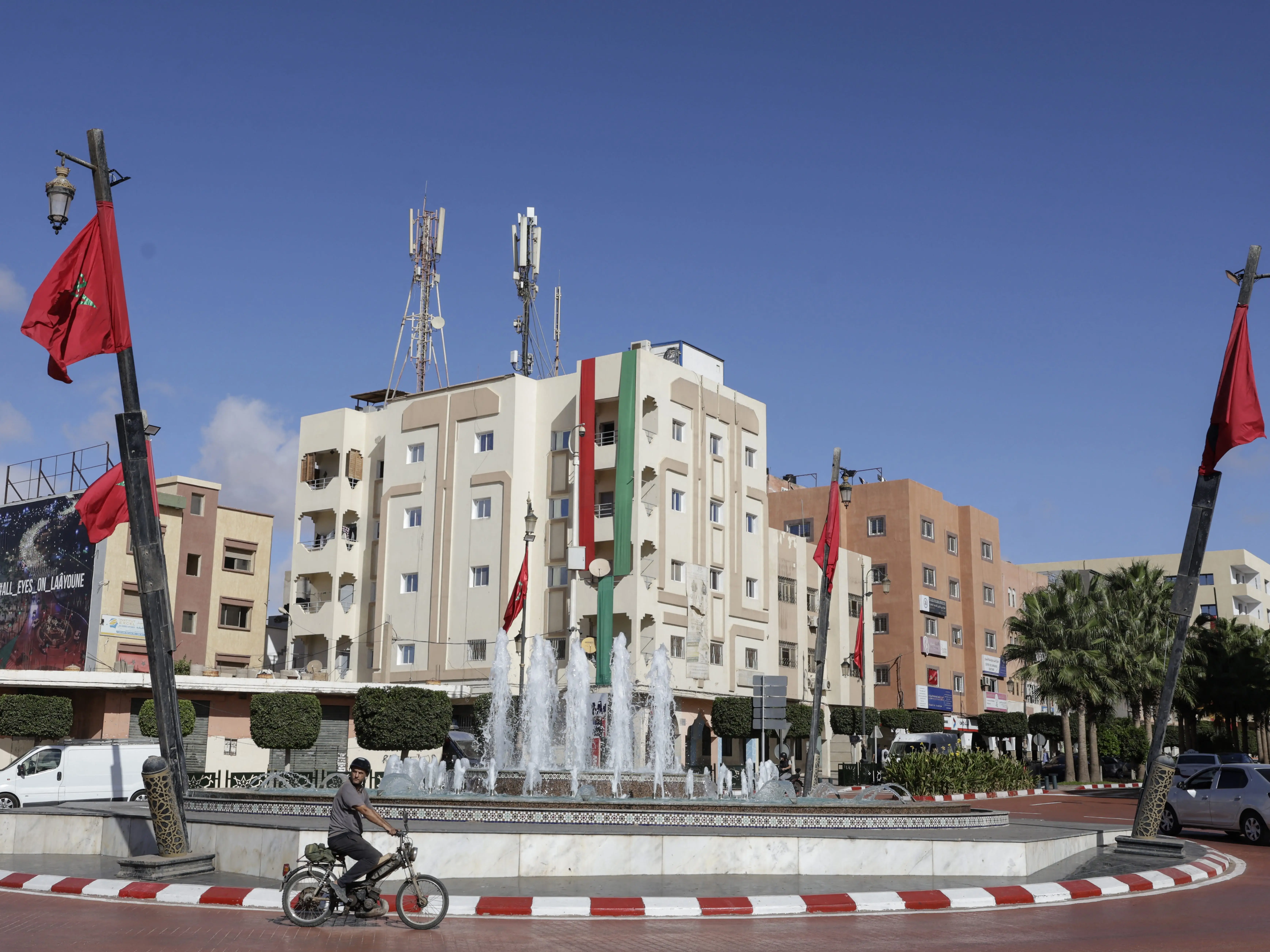 A man rides past a roundabout in Laayoune.