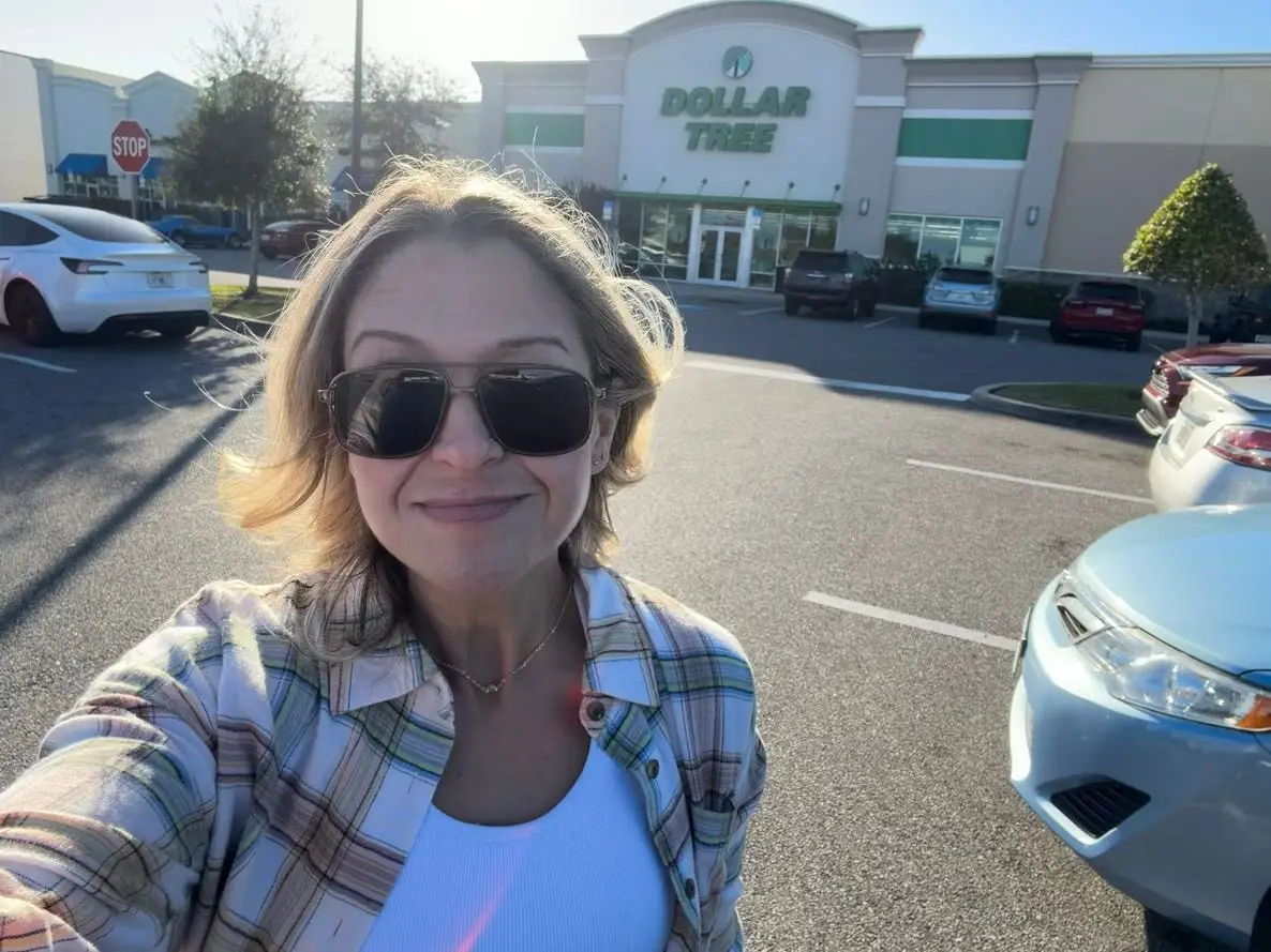 Author Terri Peters smiling in front of a Dollar Tree