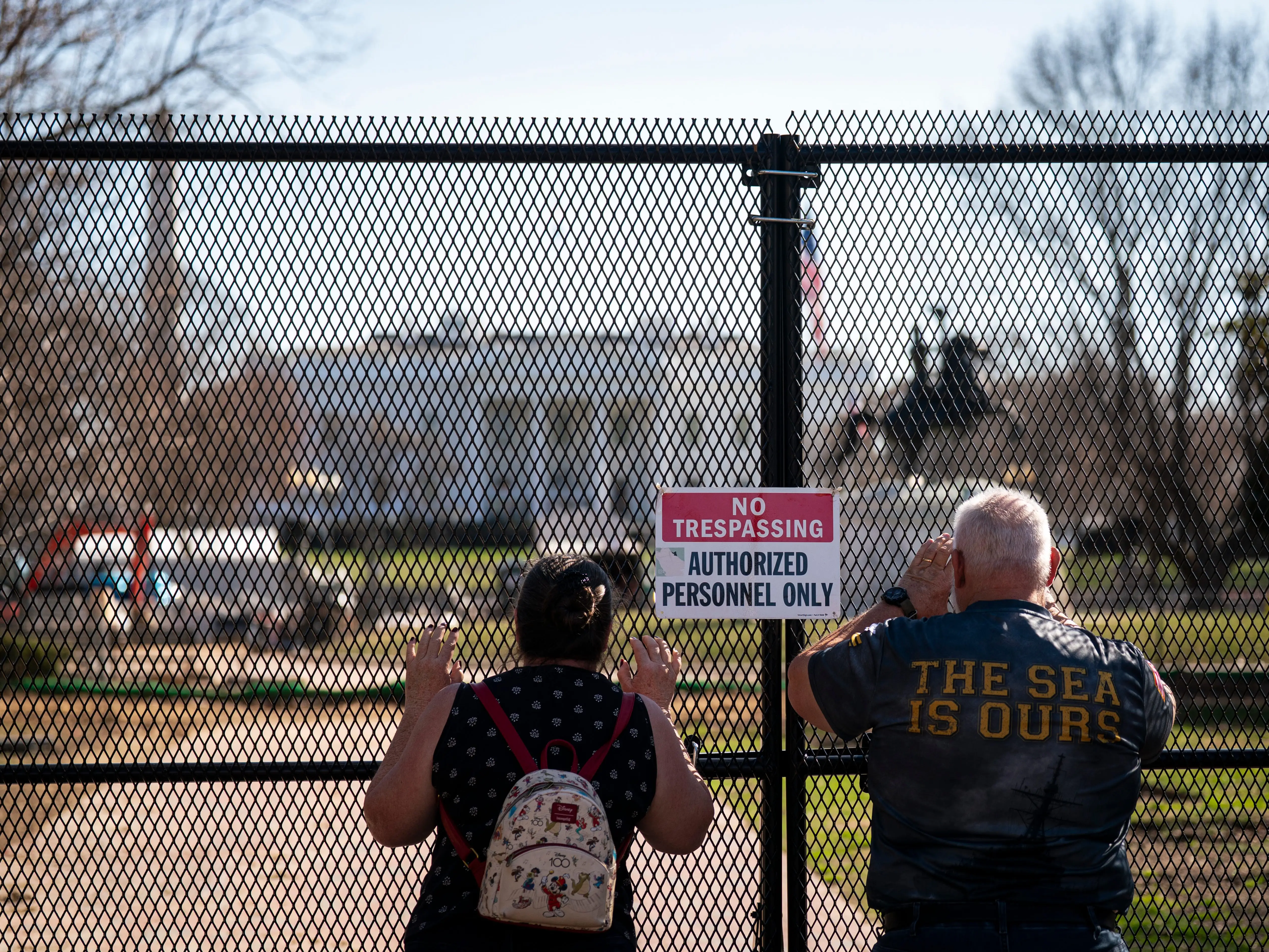 Pedestrians view ongoing construction in Lafayette Park on the north side of the White House complex, as part of a months-long 