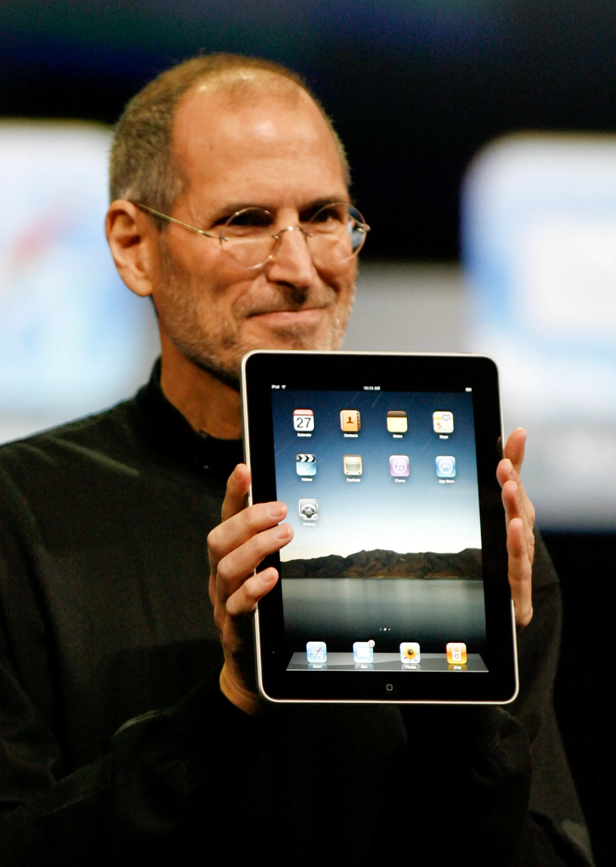 Steve Jobs holding an ipad