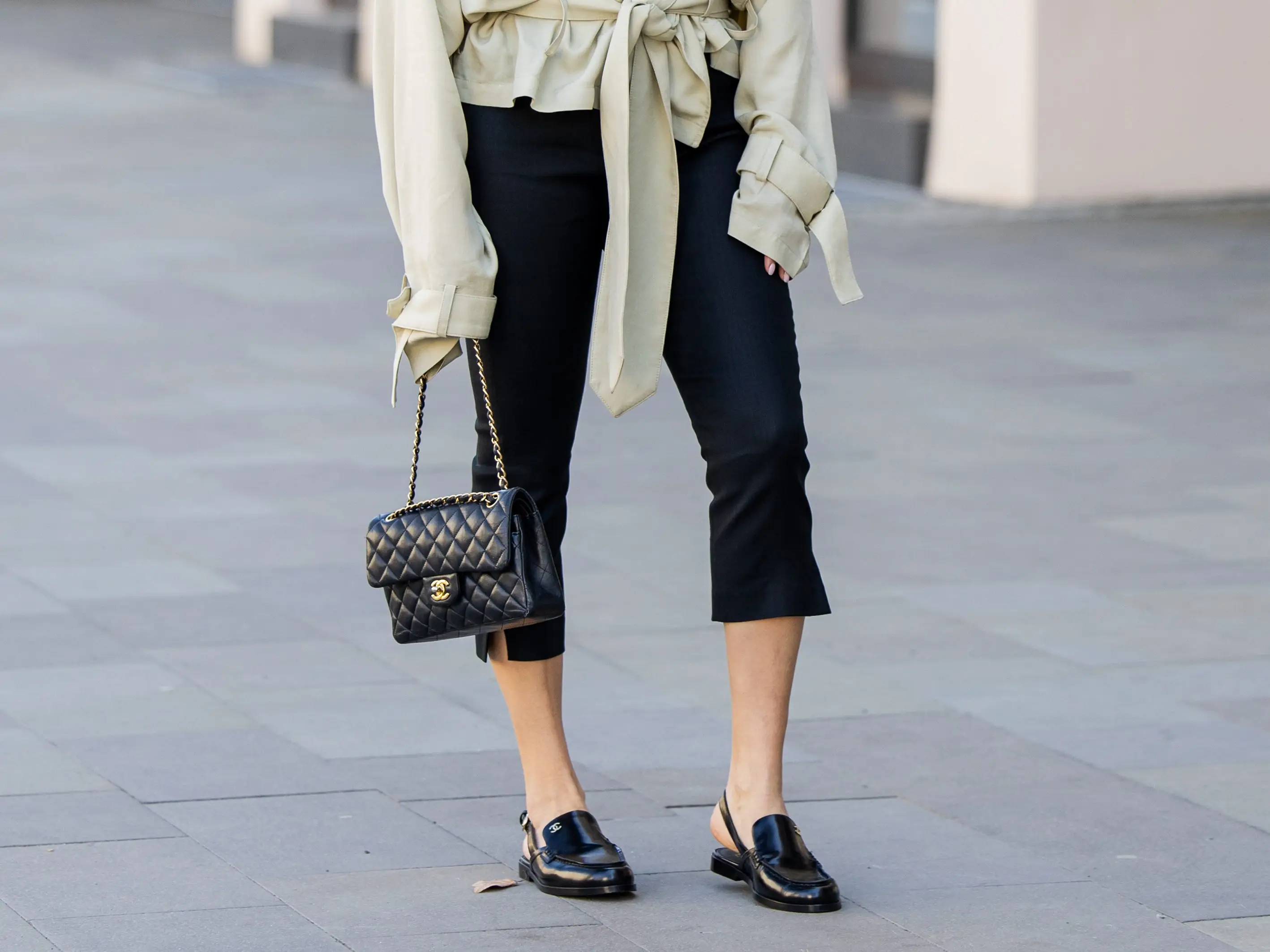 A woman wearing a pair of black capris.