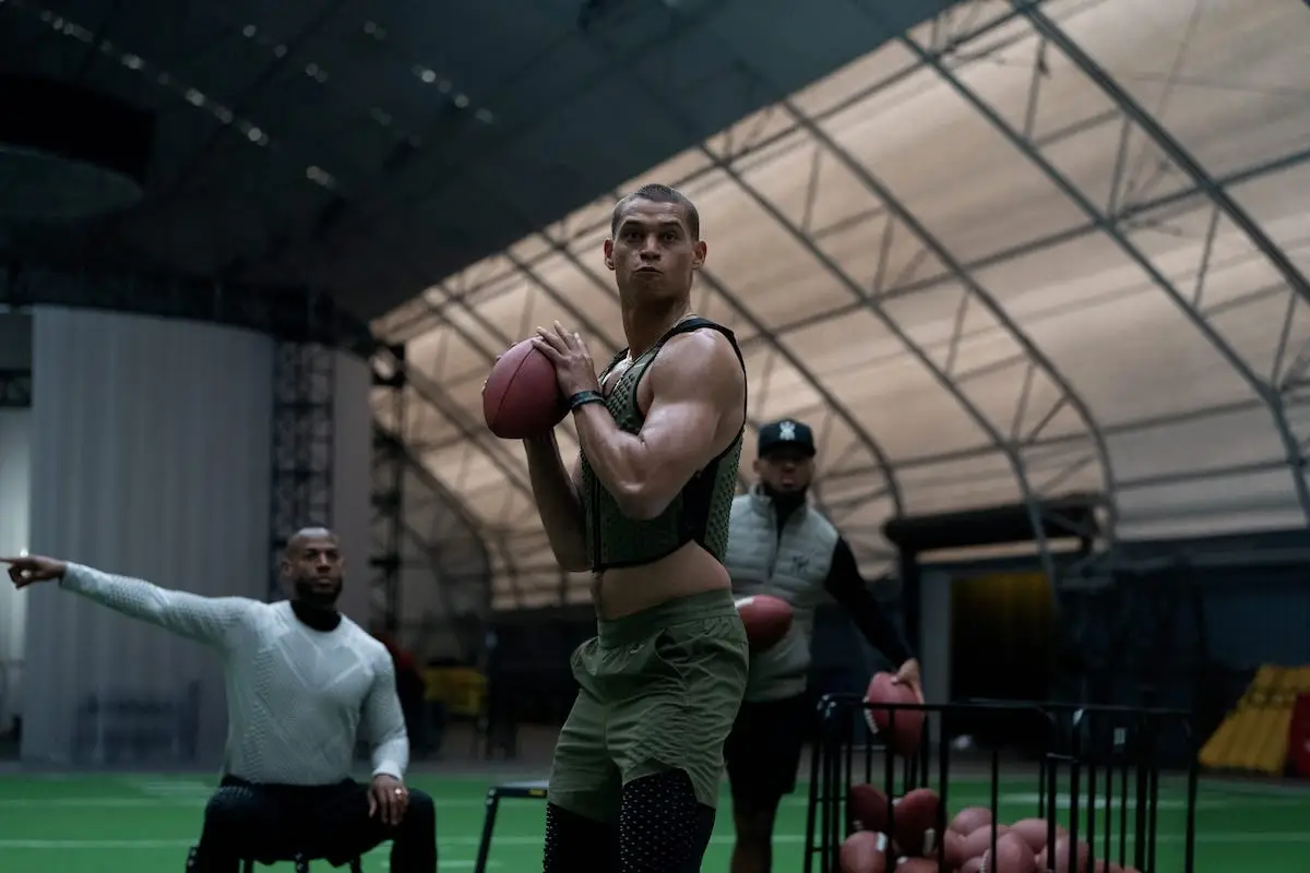 Tyriq Withers throwing a football and Marlon Wayans pointing in Him