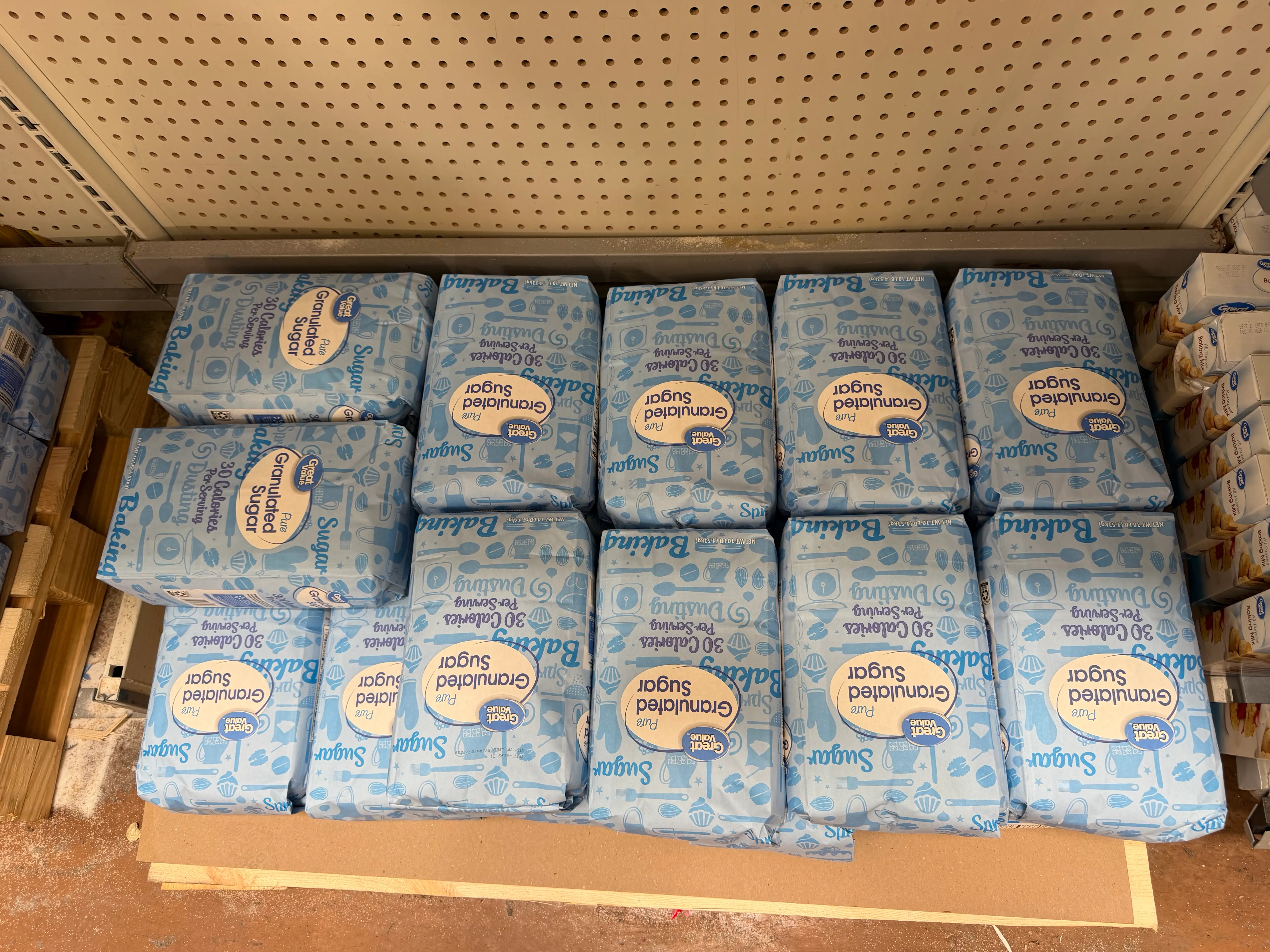 Packages of Great Value granulated sugar stacked in store