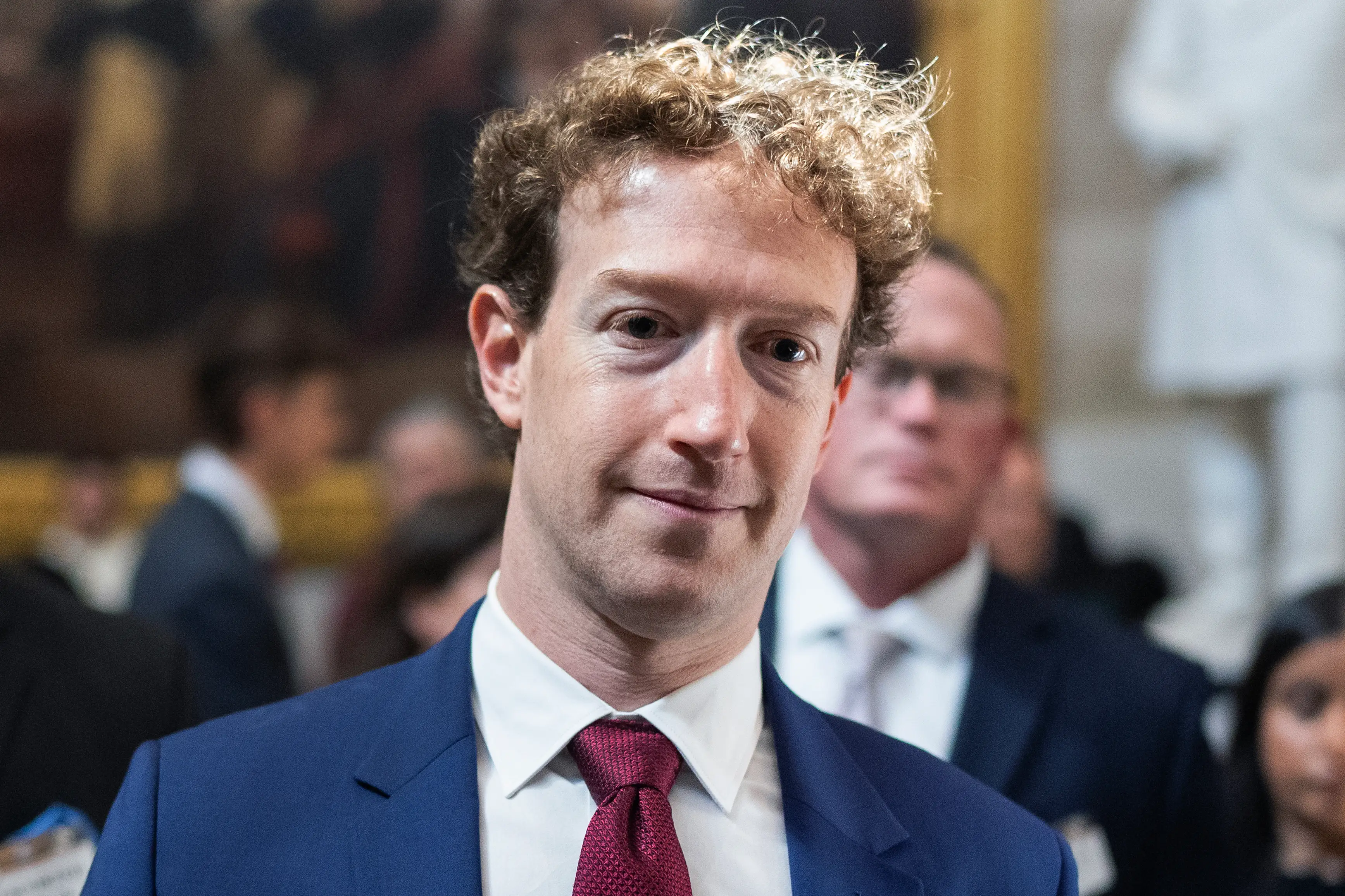 Meta CEO Mark Zuckerberg in the US Capitol, wearing a red tie and blue suit jacket.