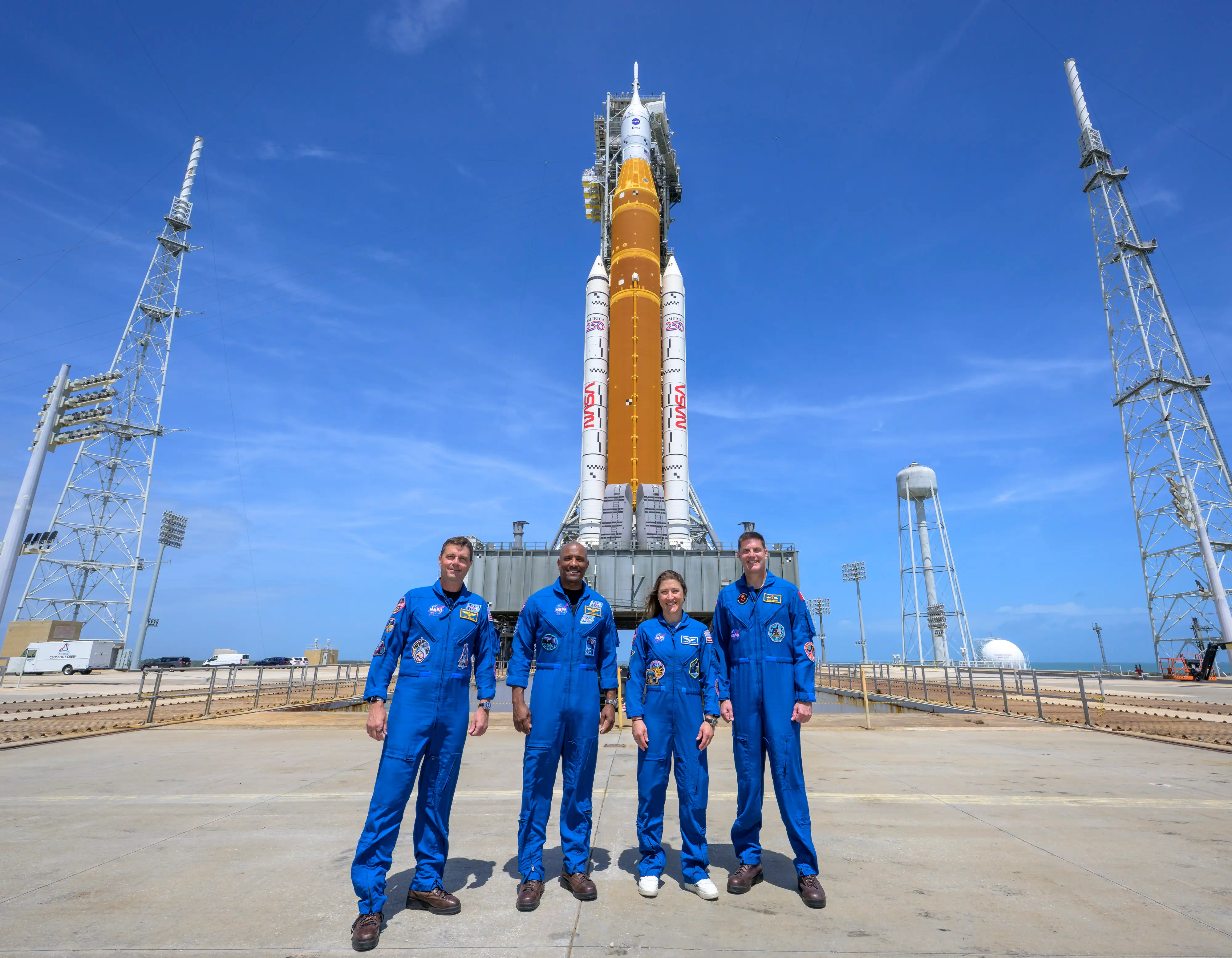 In this handout provided by NASA, NASA astronauts Reid Wiseman, Artemis II commander, left, Victor Glover, Artemis II pilot, Christina Koch, Artemis II mission specialist, and CSA (Canadian Space Agency) astronaut Jeremy Hansen, Artemis II mission specialist, right, stop for a group photograph as they visit NASA's Artemis II SLS