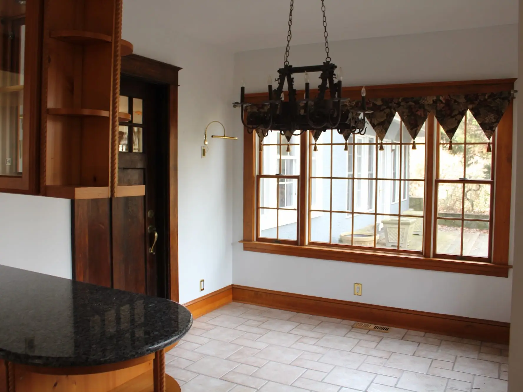 A kitchen with windows and a doorway.