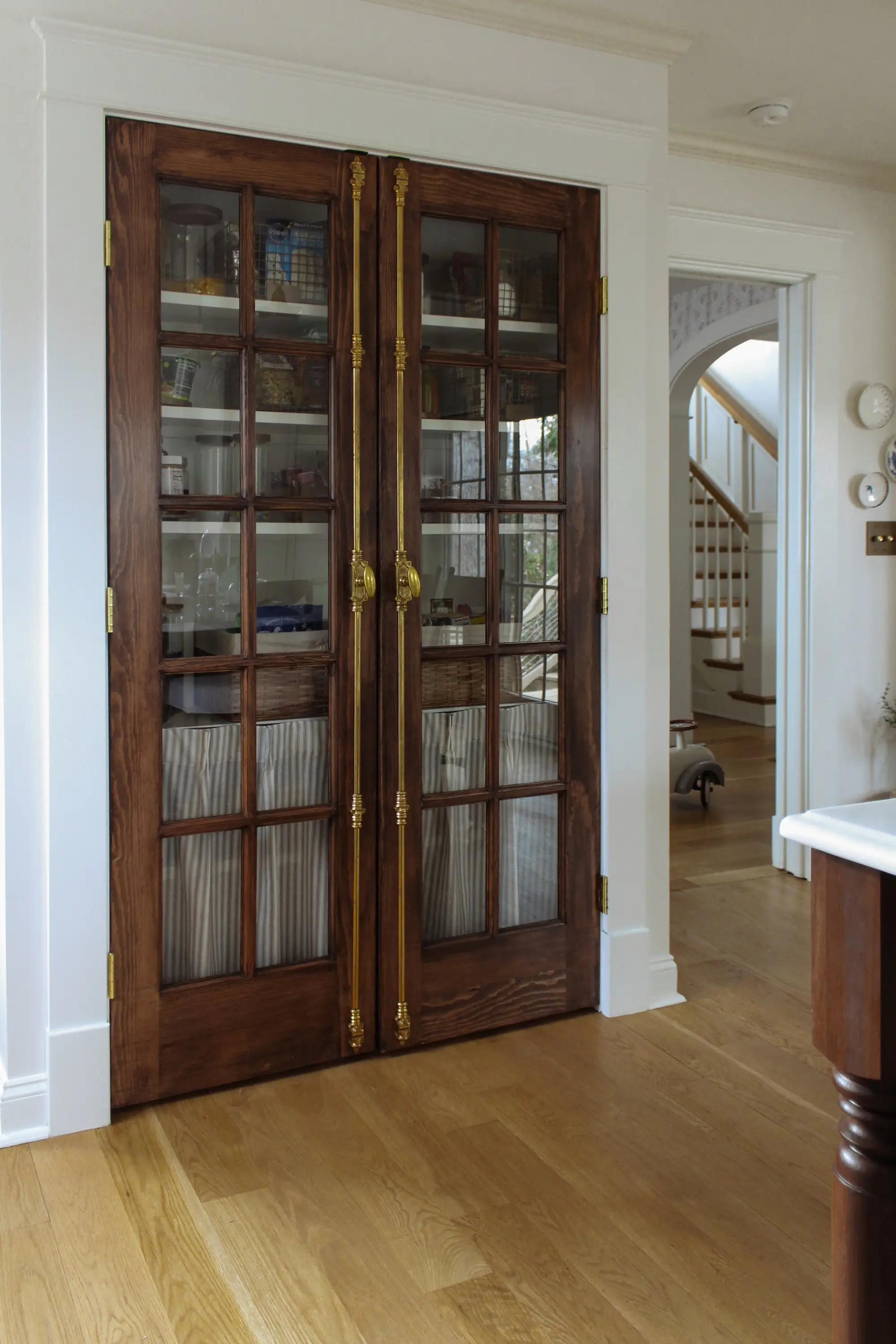 A cabinet with glass panes on a wooden door.