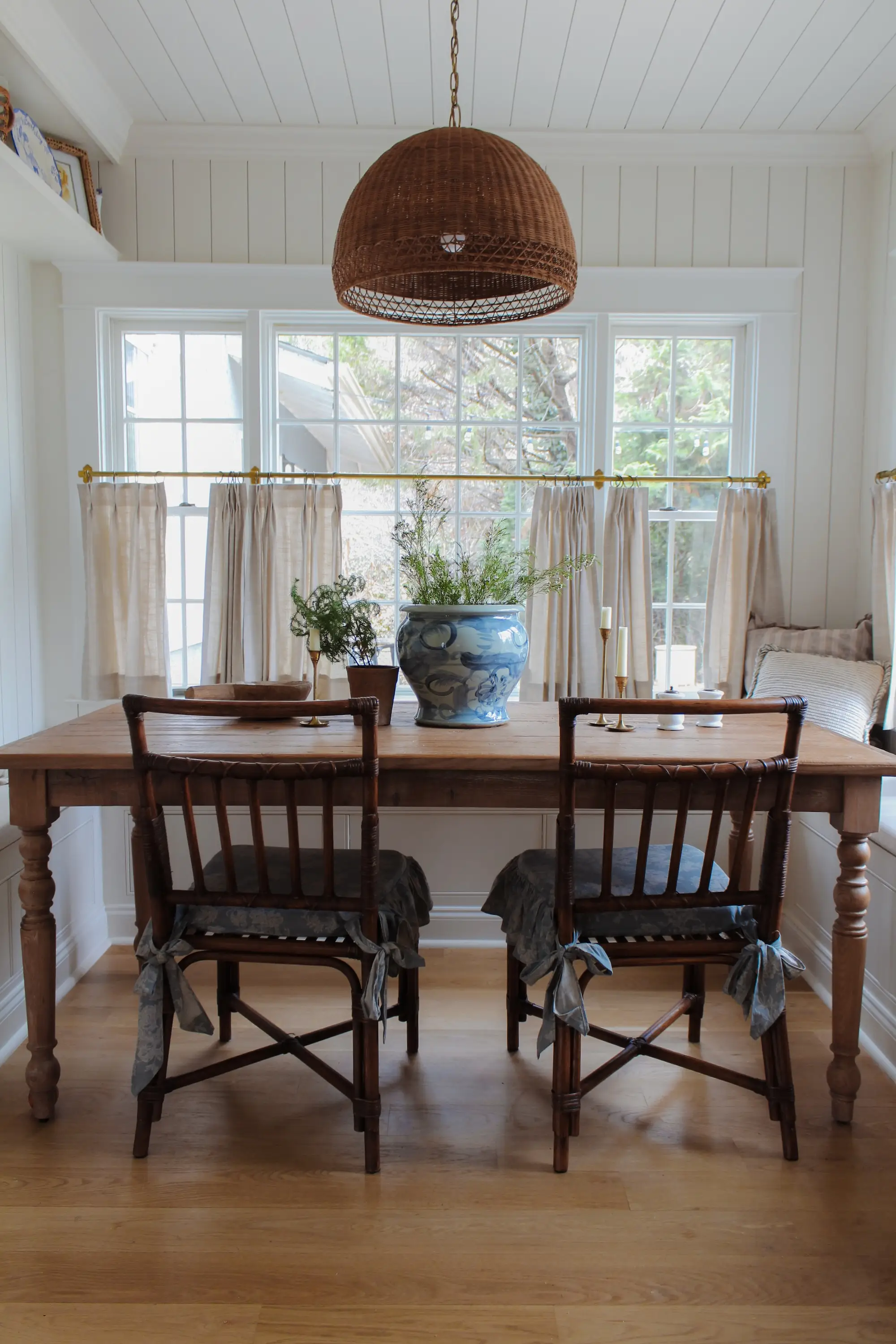 A table surrounded by bench seating in a kitchen.