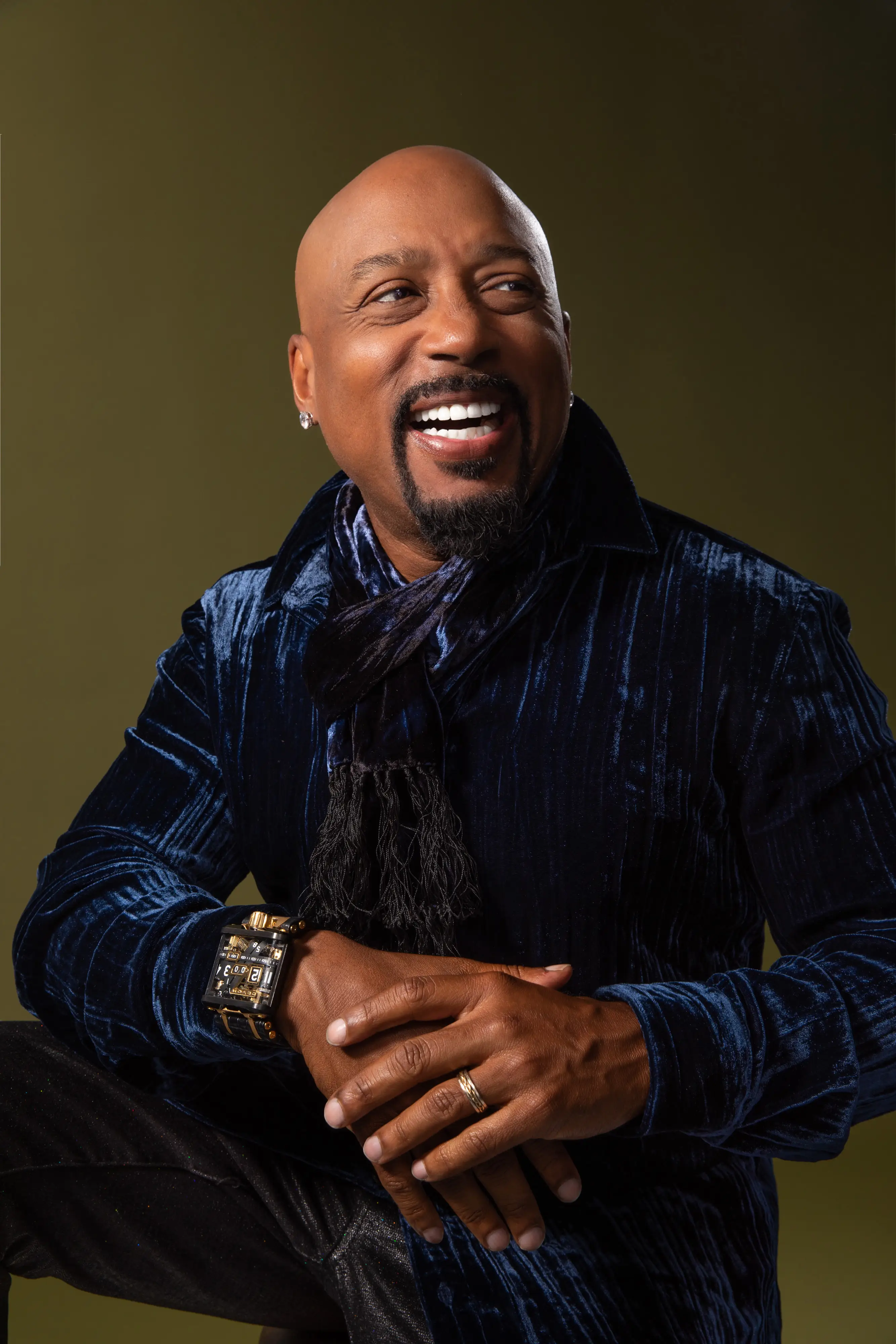 a head shot of Daymond John on a green background