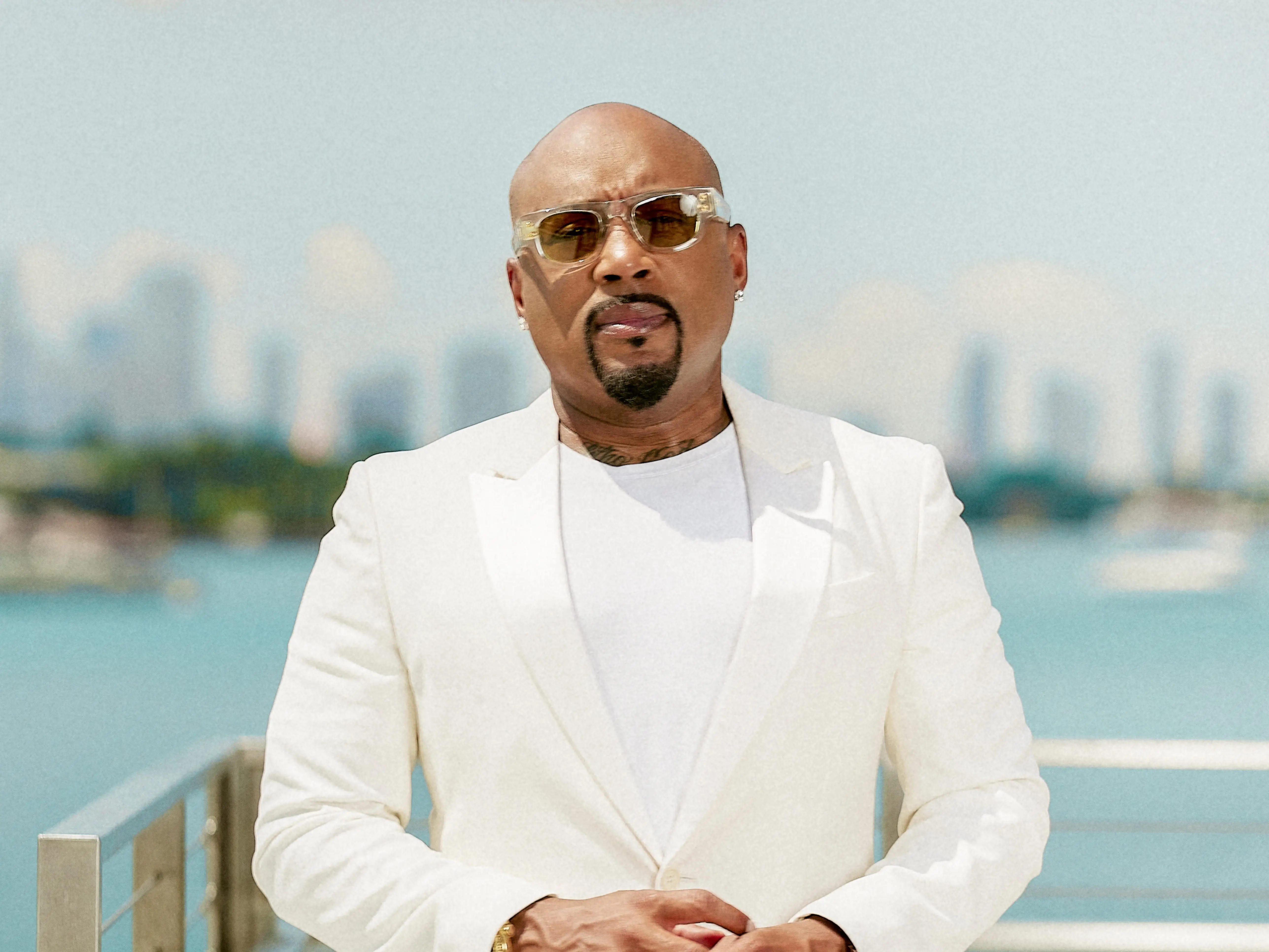 Daymond John poses in a white outfit in Miami