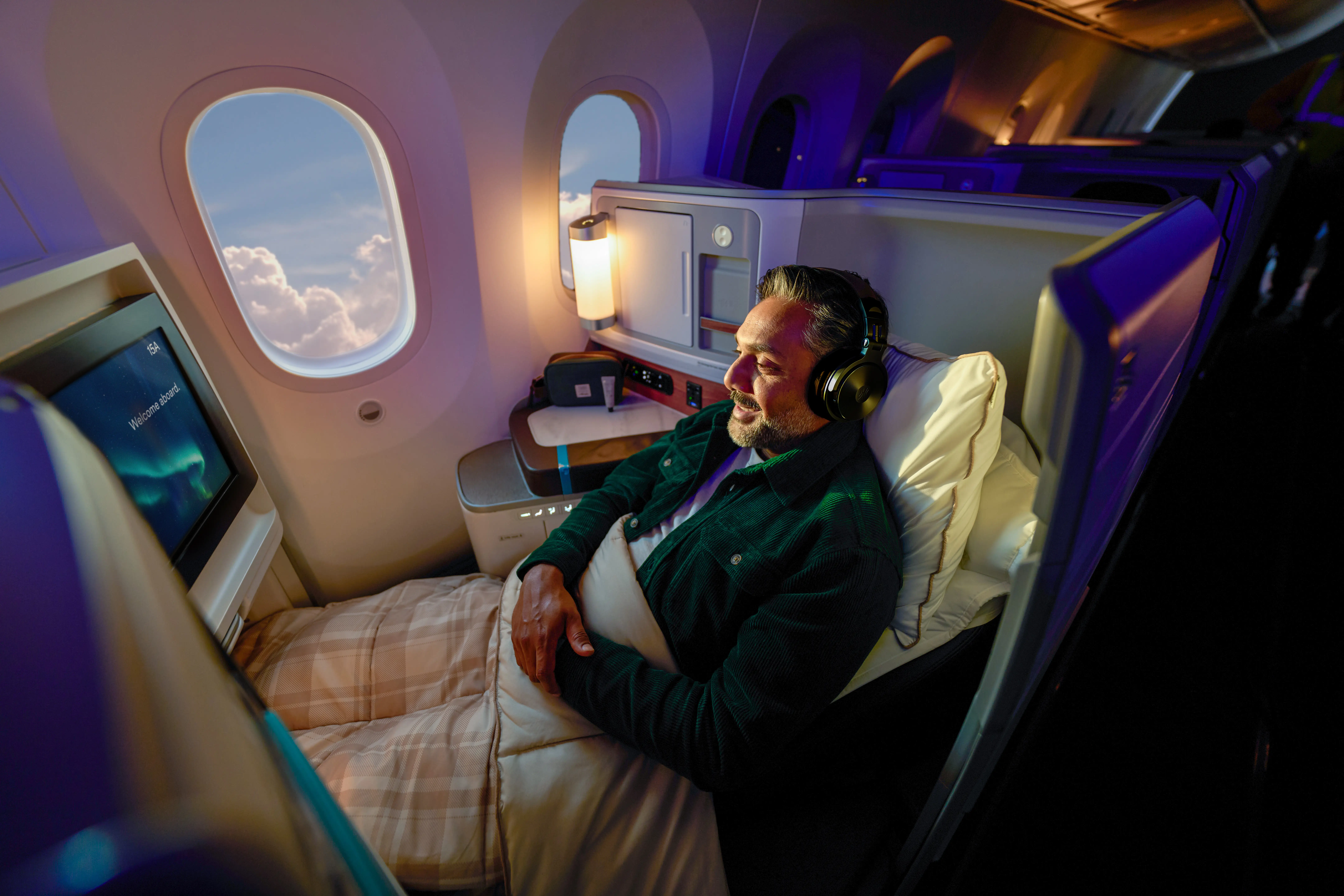 A man sitting in Alaska 787 business class.