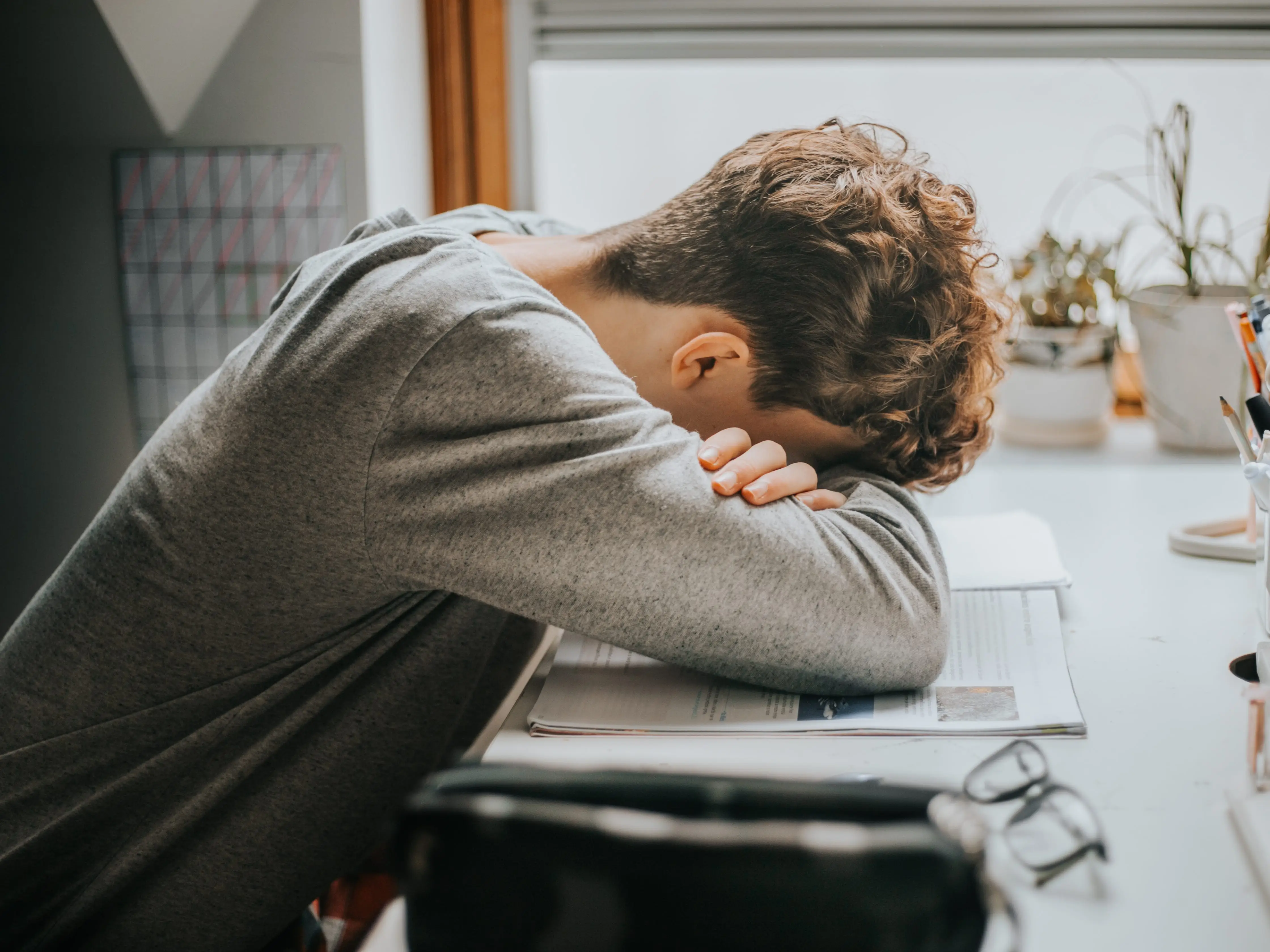 Person face down on book