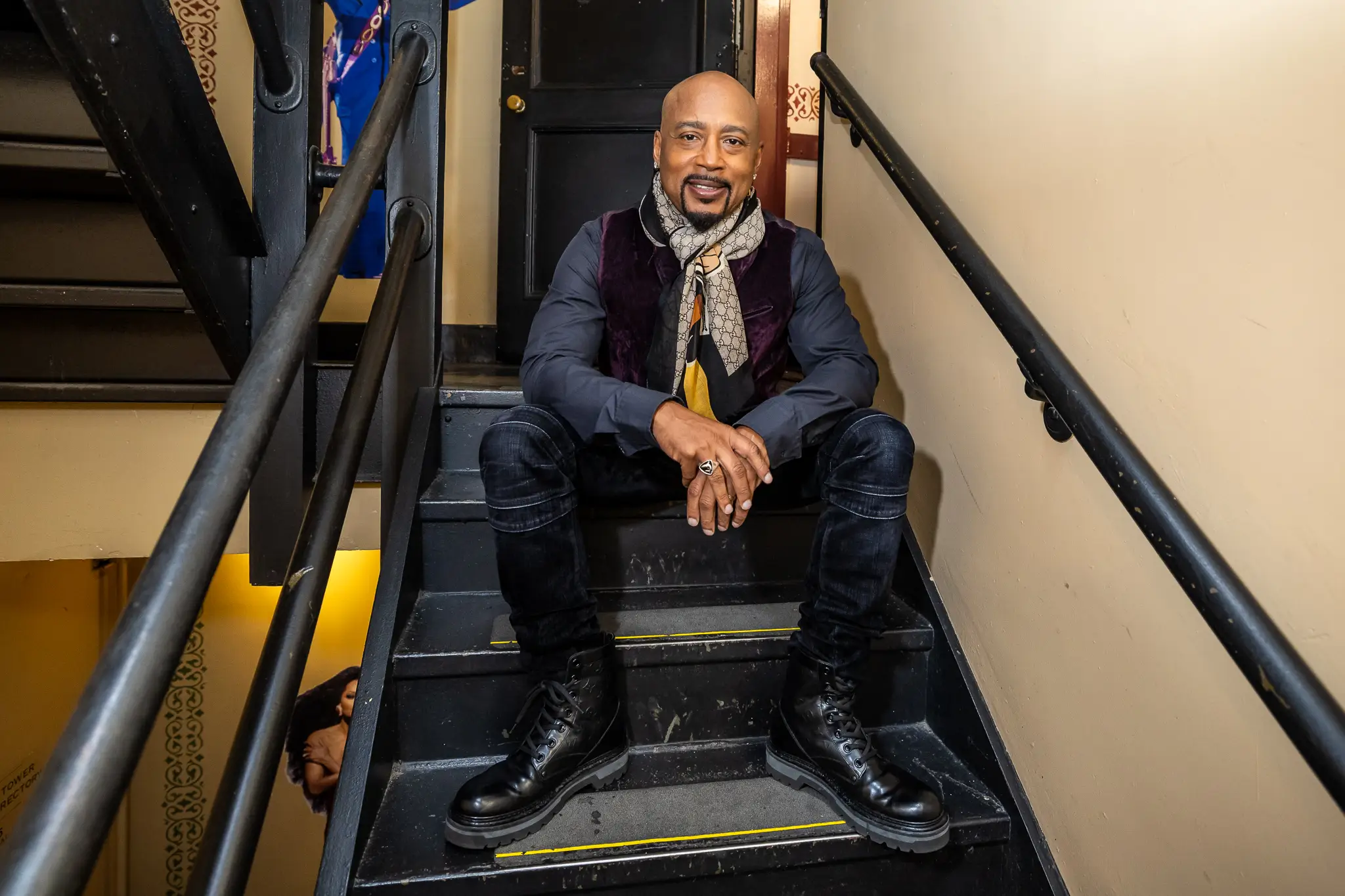 head shot of Daymond John sitting on stairs