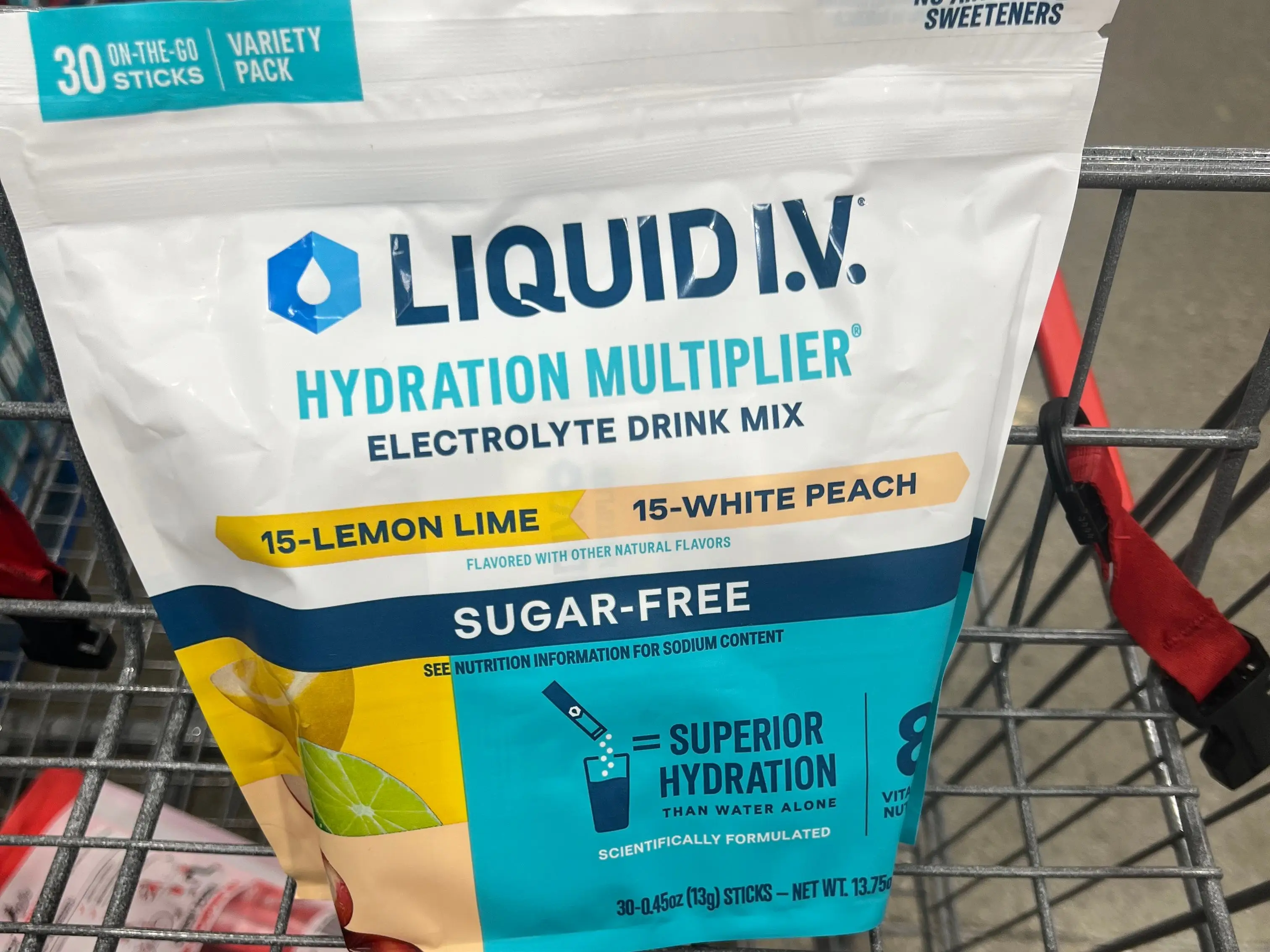 A bag of Liquid IV hydration multipliers in a Costco shopping cart.