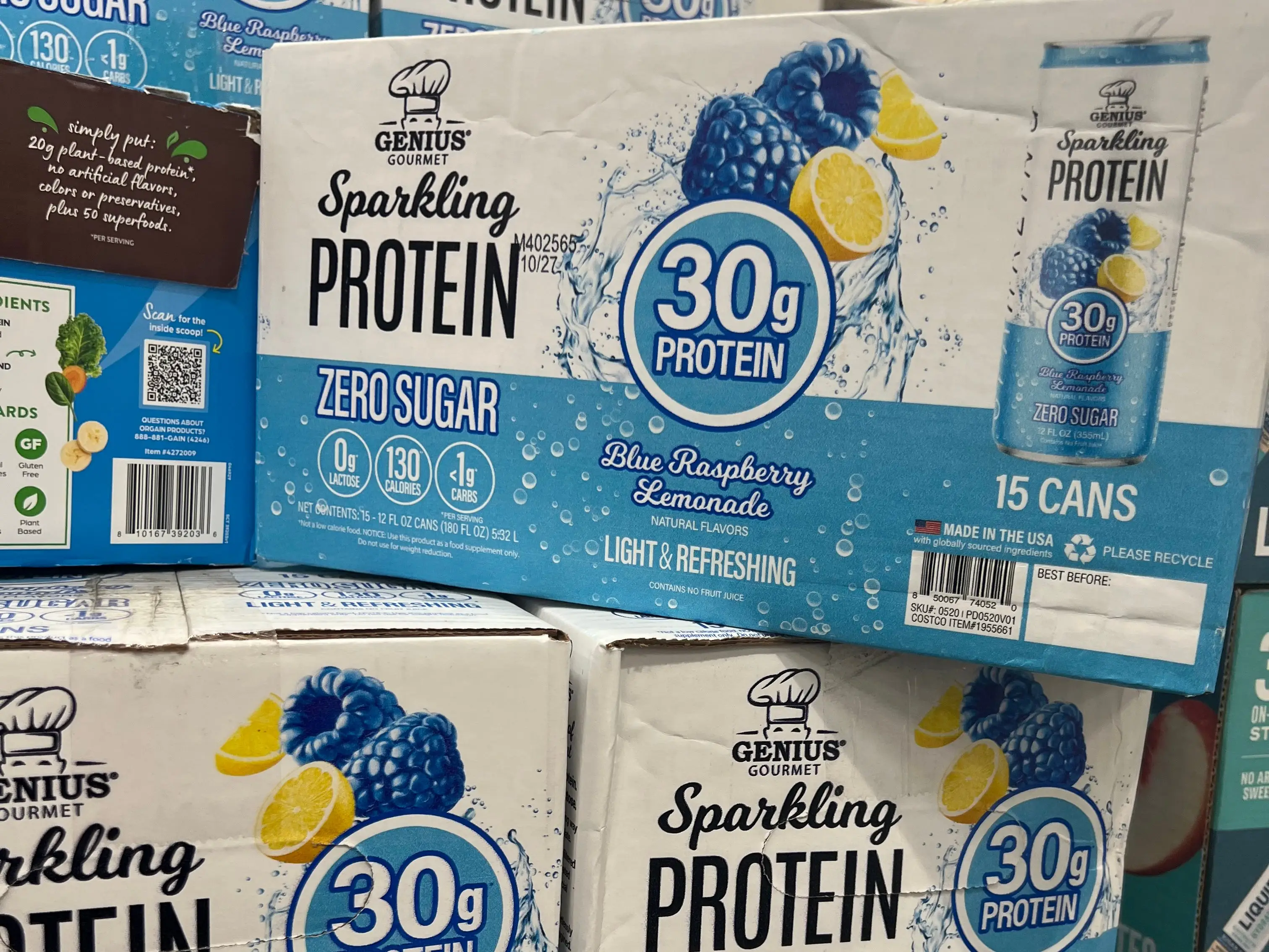 Boxes of Genius Gourmet sparkling protein drinks on display at Costco.