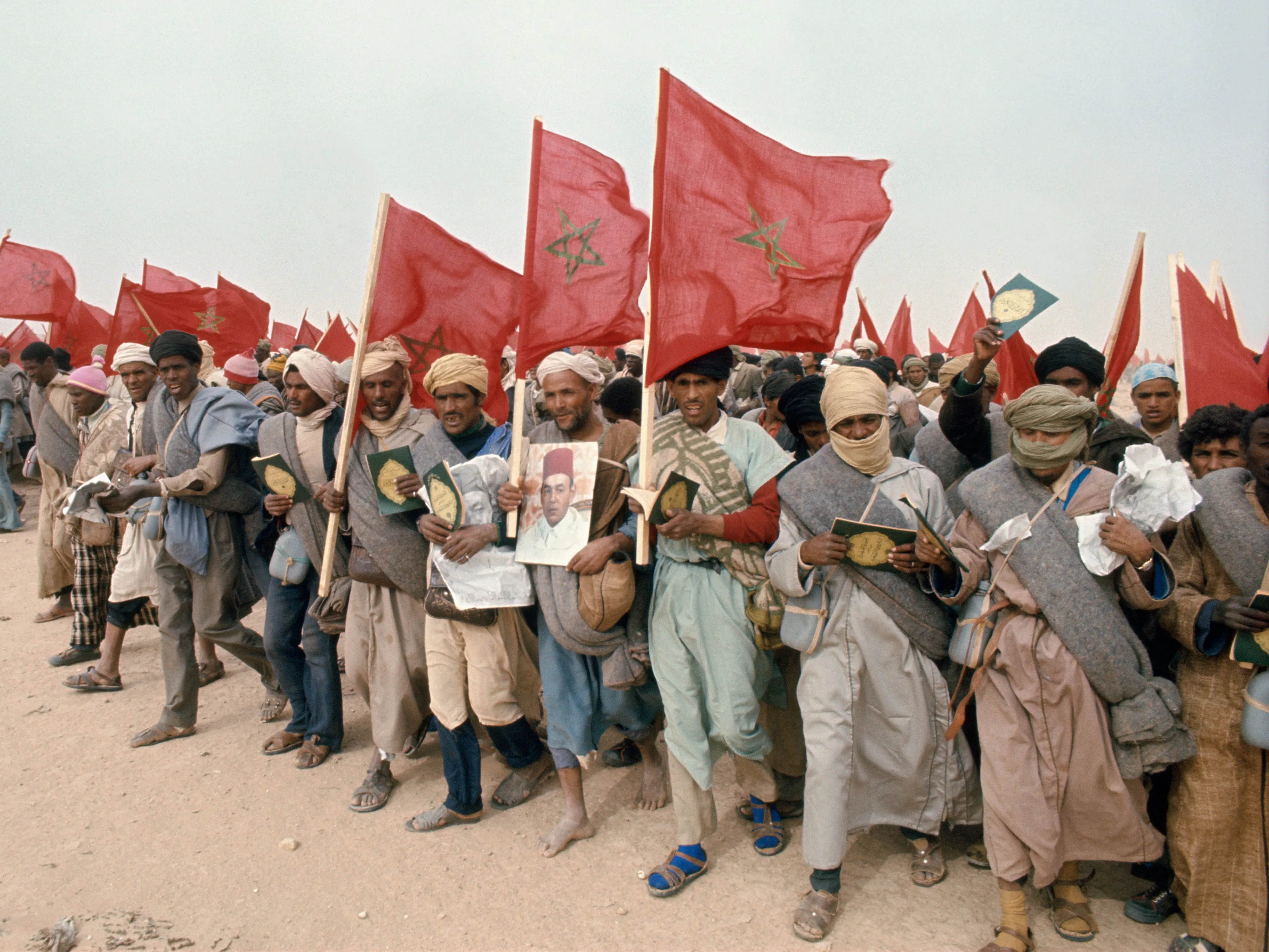 Moroccans walking with national flags.