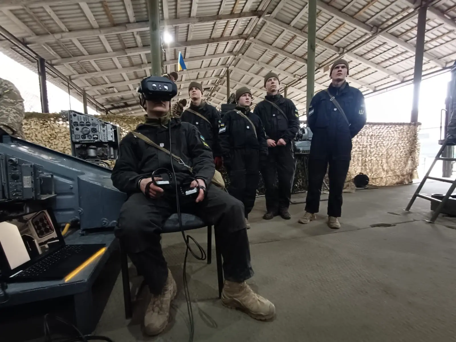 A man uses a Varjo headset and sensors as four others watch.