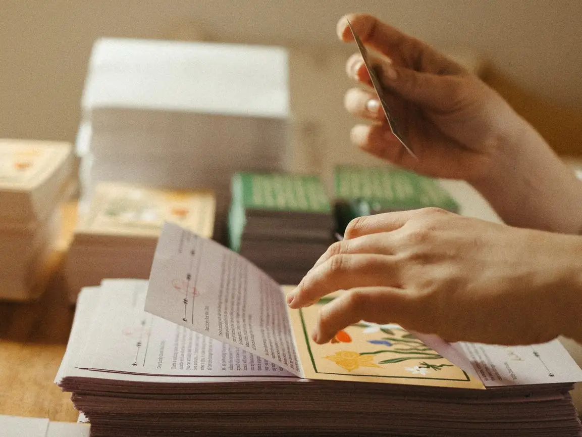 Hands folding letters.