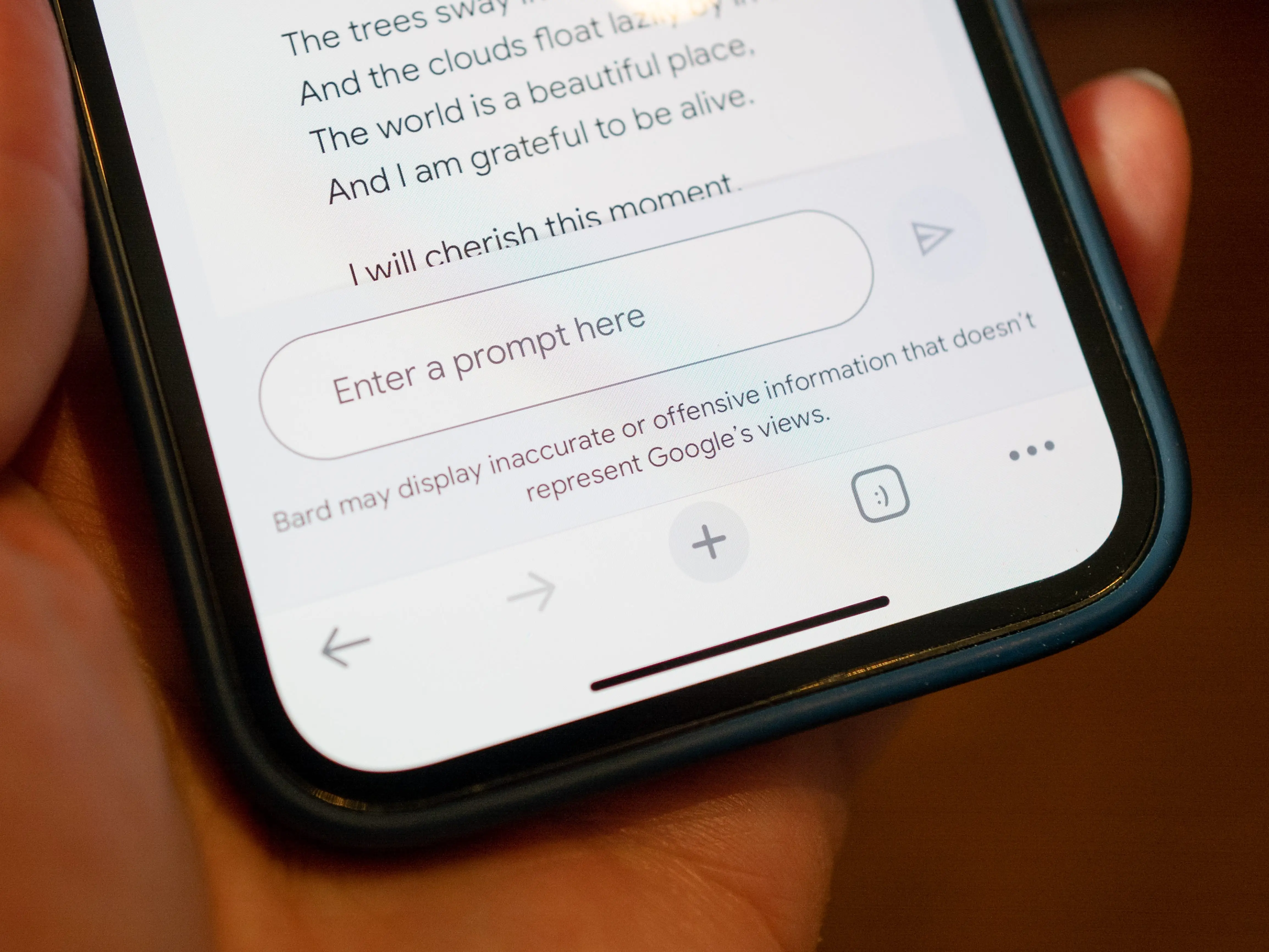 A person's hand holding an iPhone using the Google Bard generative AI language model (chatbot) with a prompt entry field, Lafayette, California, in March 2023.
