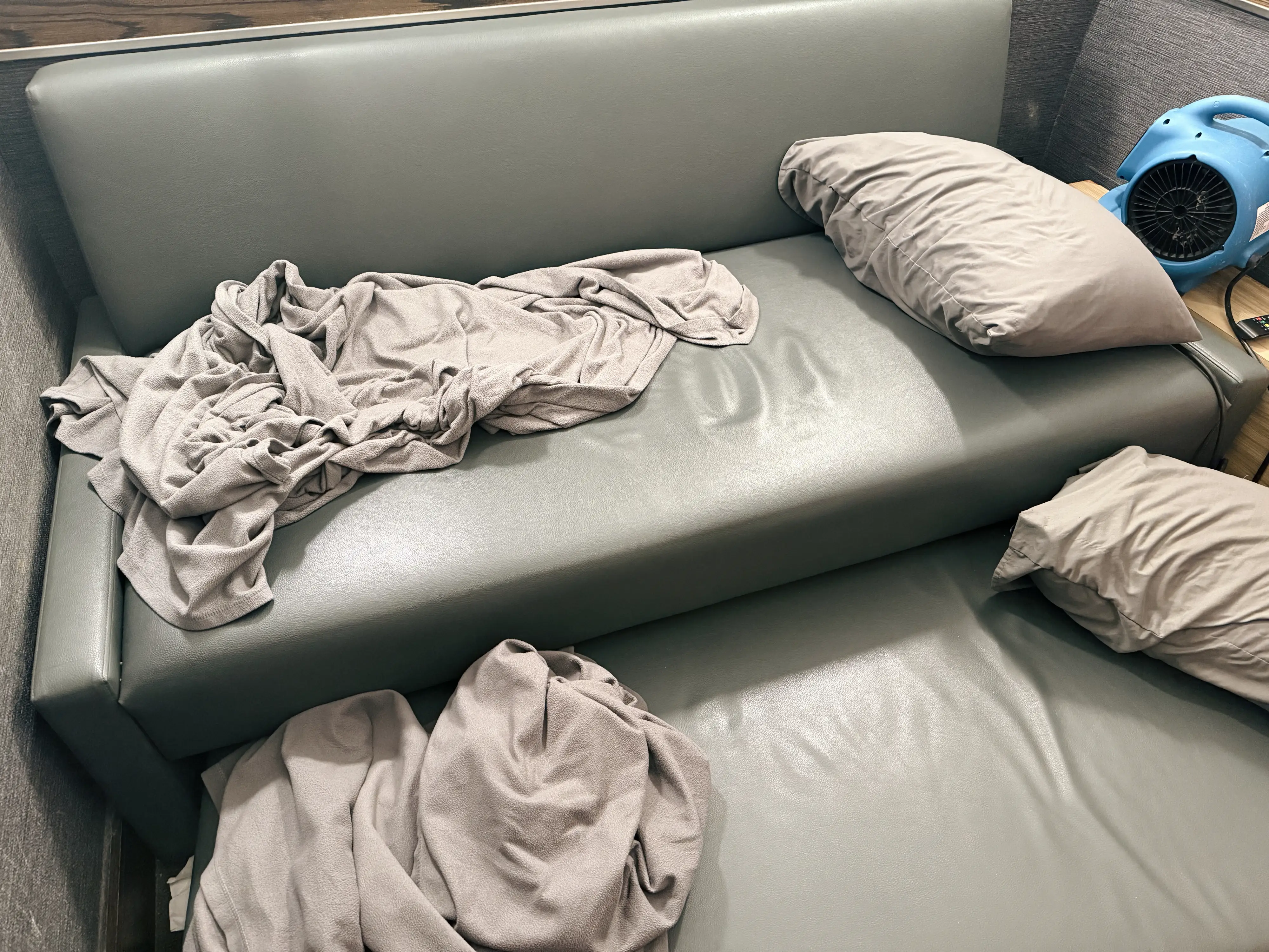 Trundle bed in Minute Suites CLT Gold Rush Room with pillowss, blankets