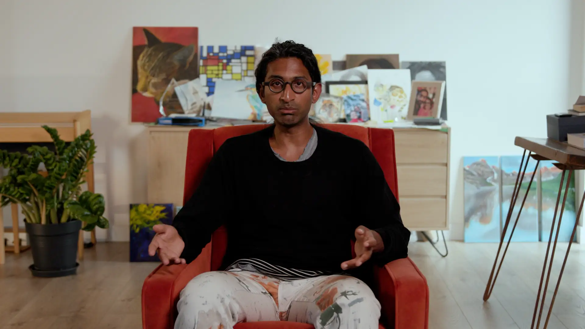 Ramana Kumar sitting in a red chair with a black long sleeved shirt.