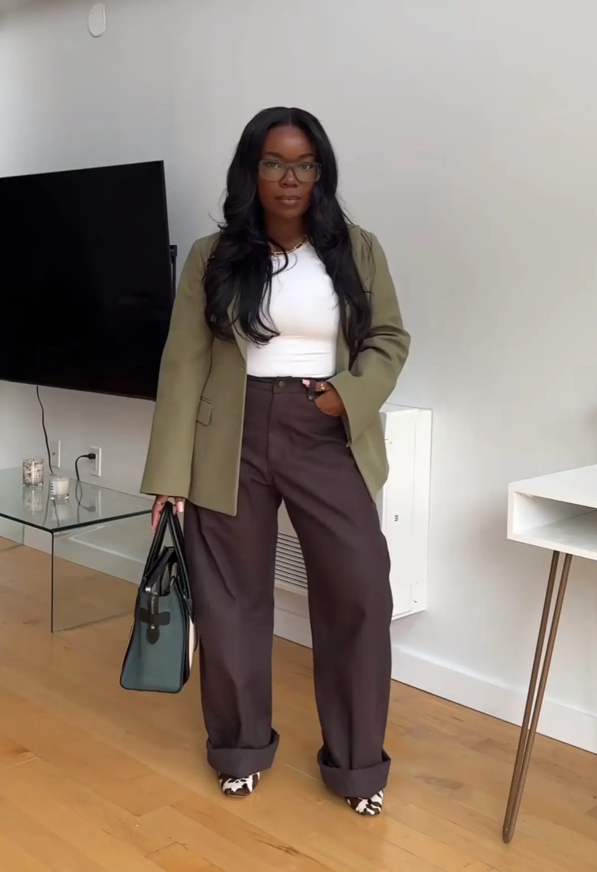 Crystal McDuffy in a work outfit — a green blazer, white top, and brown pants