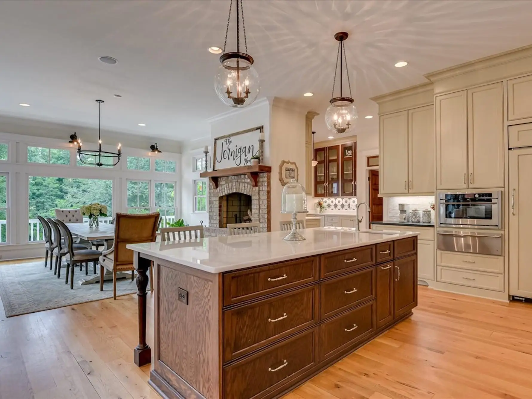 An open concept room with a kitchen and a large dining table.