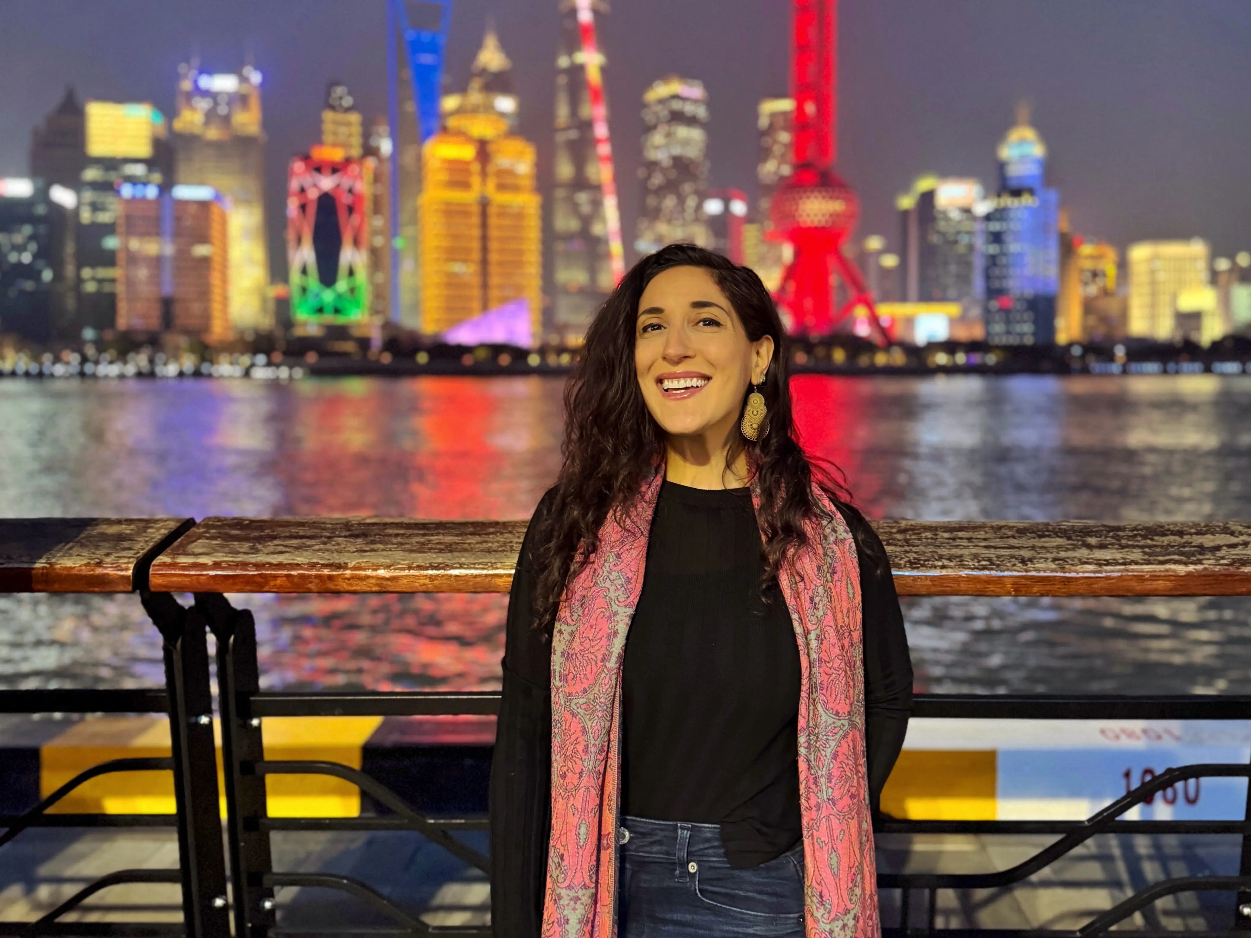 Woman standing with Shanghai skyline in the background.