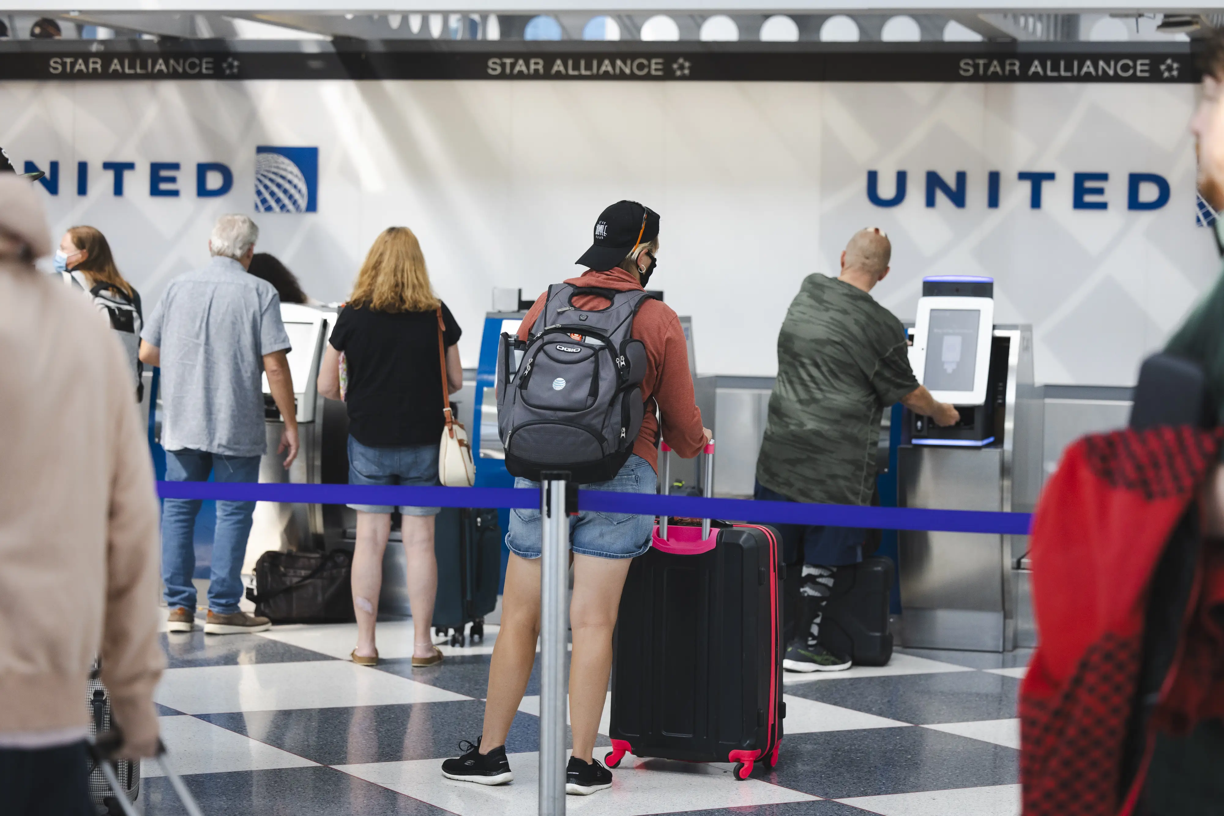 Travelers wait in line at the United Airlines bag drop at O'Hare International Airport ahead of the Labor Day holiday weekend in Chicago, Illinois, US, on Friday, Sept. 1, 2023.
