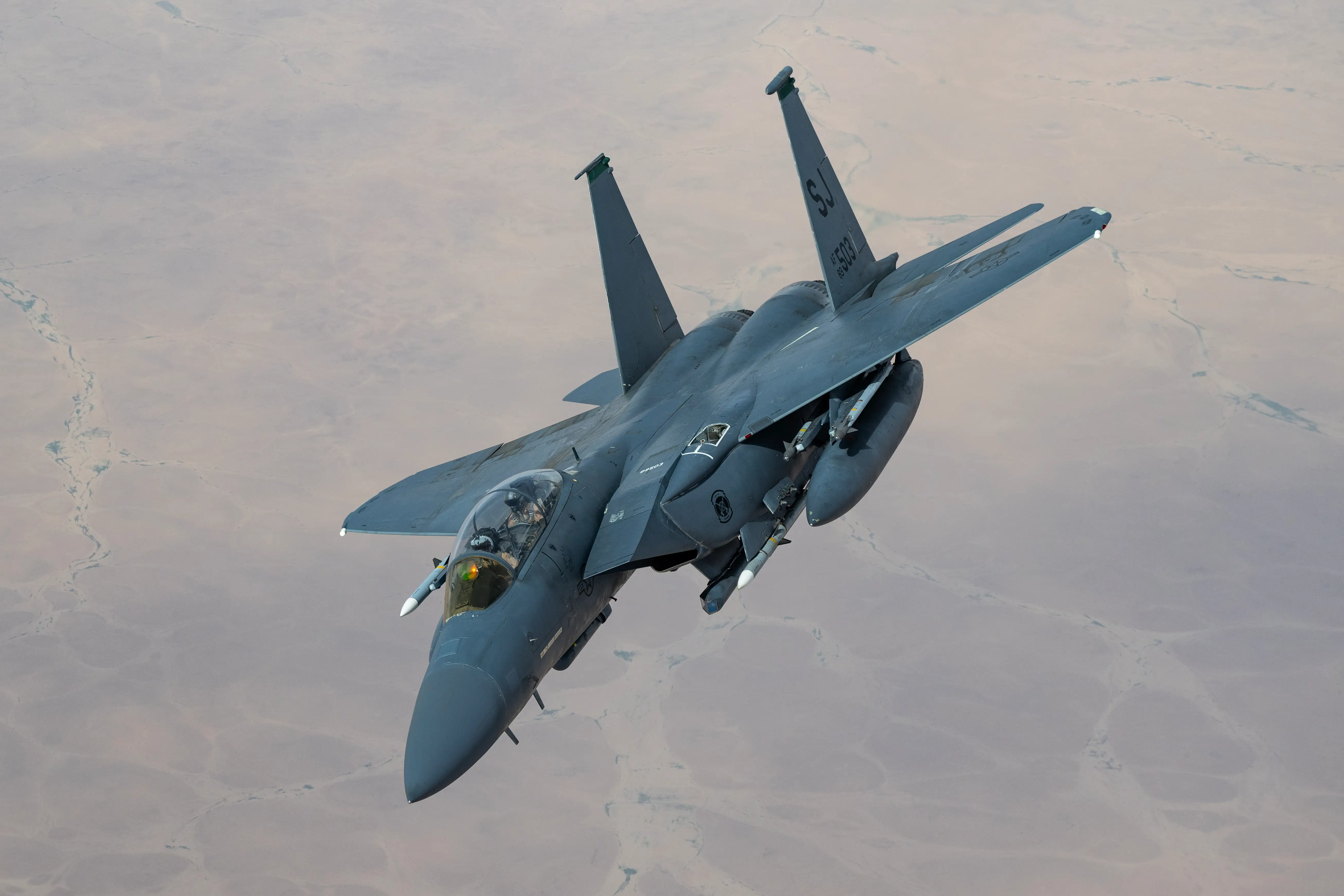 A US Air Force F-15E Strike Eagle from Seymour-Johnson Air Force Base's 335th Fighter Squadron breaks off after receiving fuel from a KC-135 Stratotanker from the Tennessee Air National Guard's 151st Air Refueling Squadron, over the US Central Command area of responsibility, April 20, 2024.