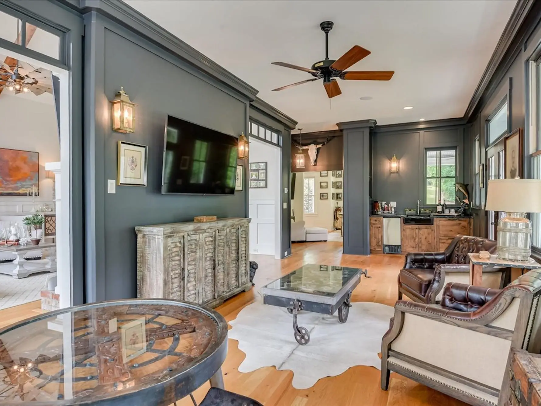 A living area with dark blue walls and dark furniture.