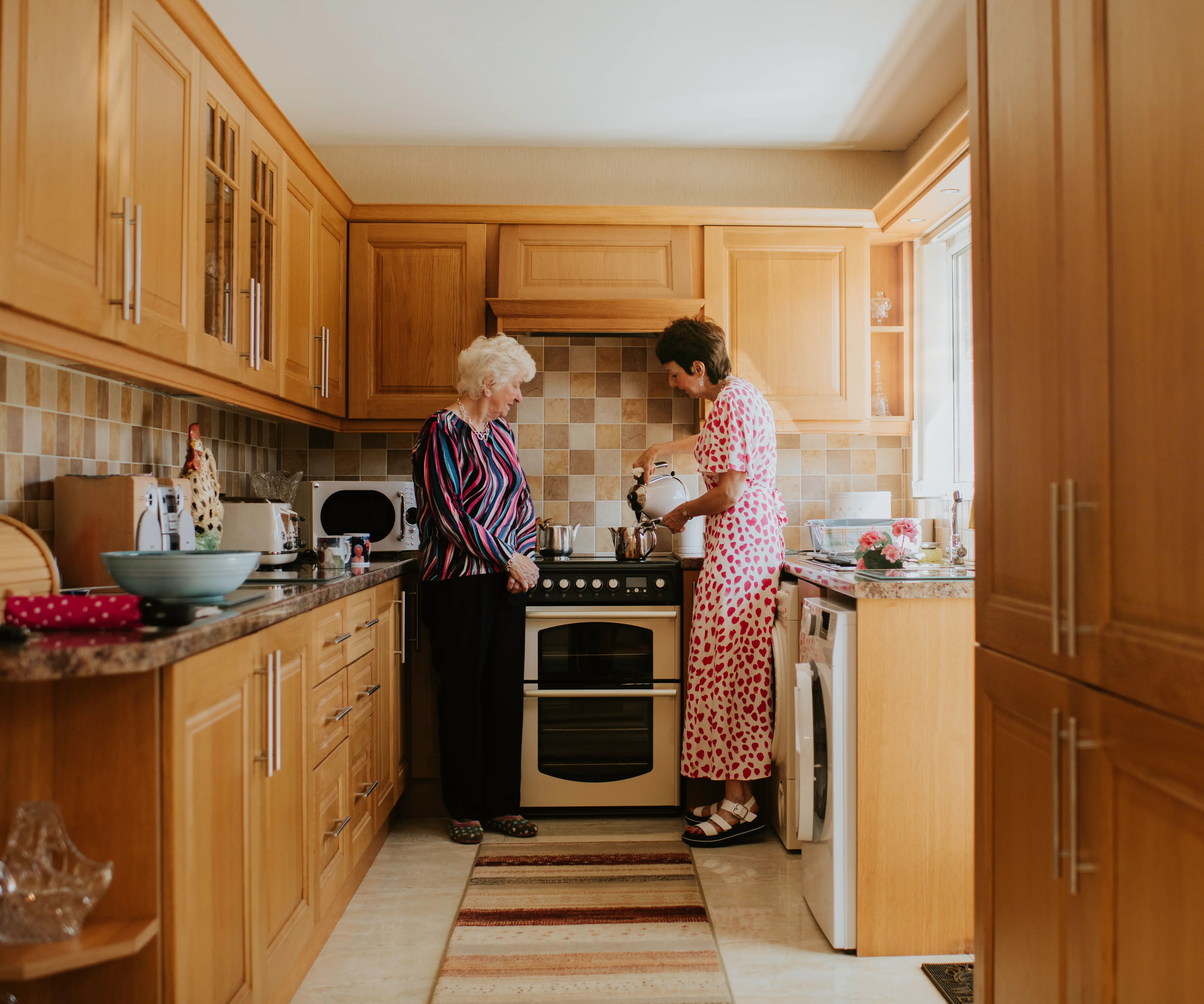 Women at kitchen making tea