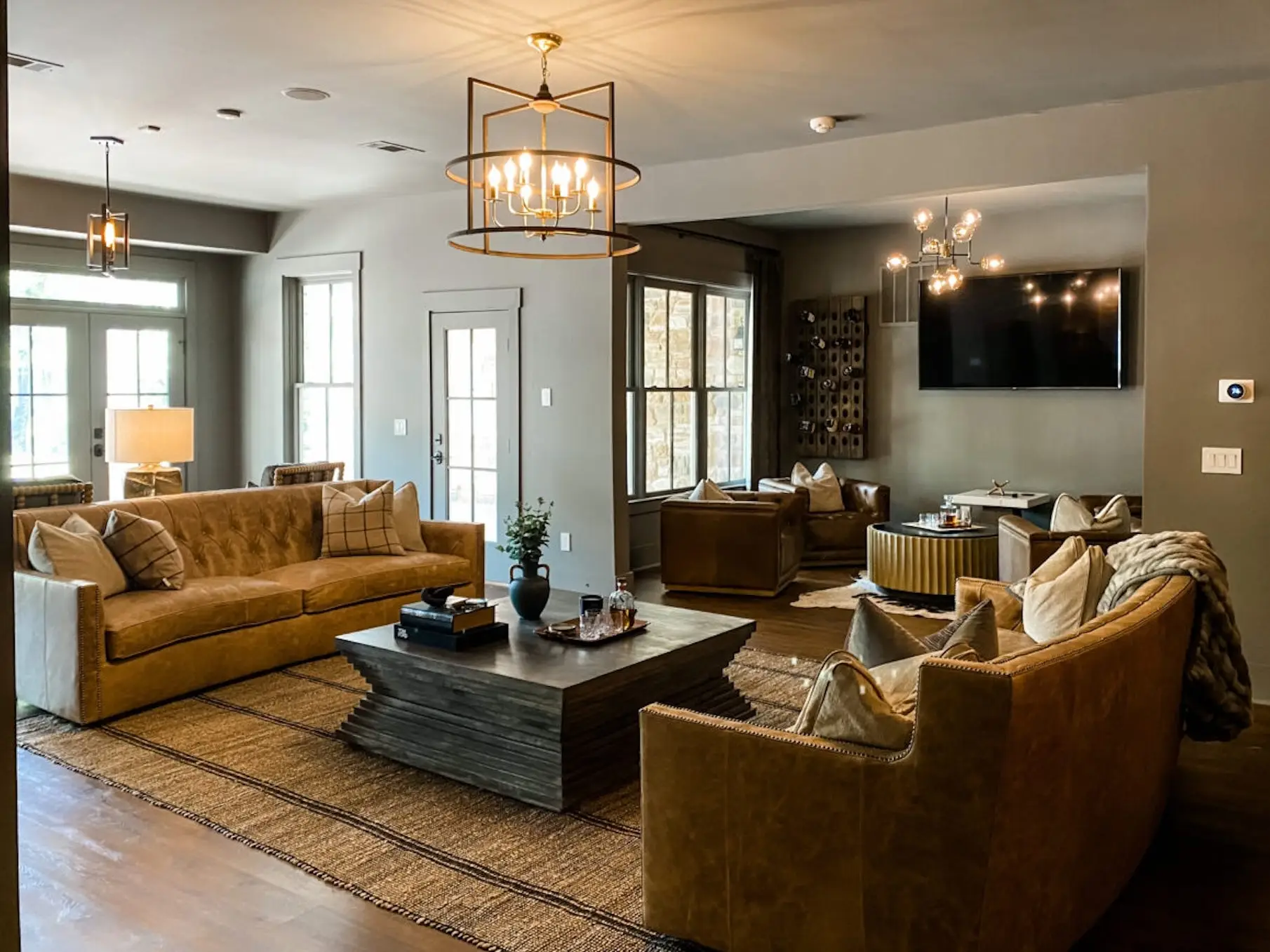 A living area in a basement with a whiskey room in the back.