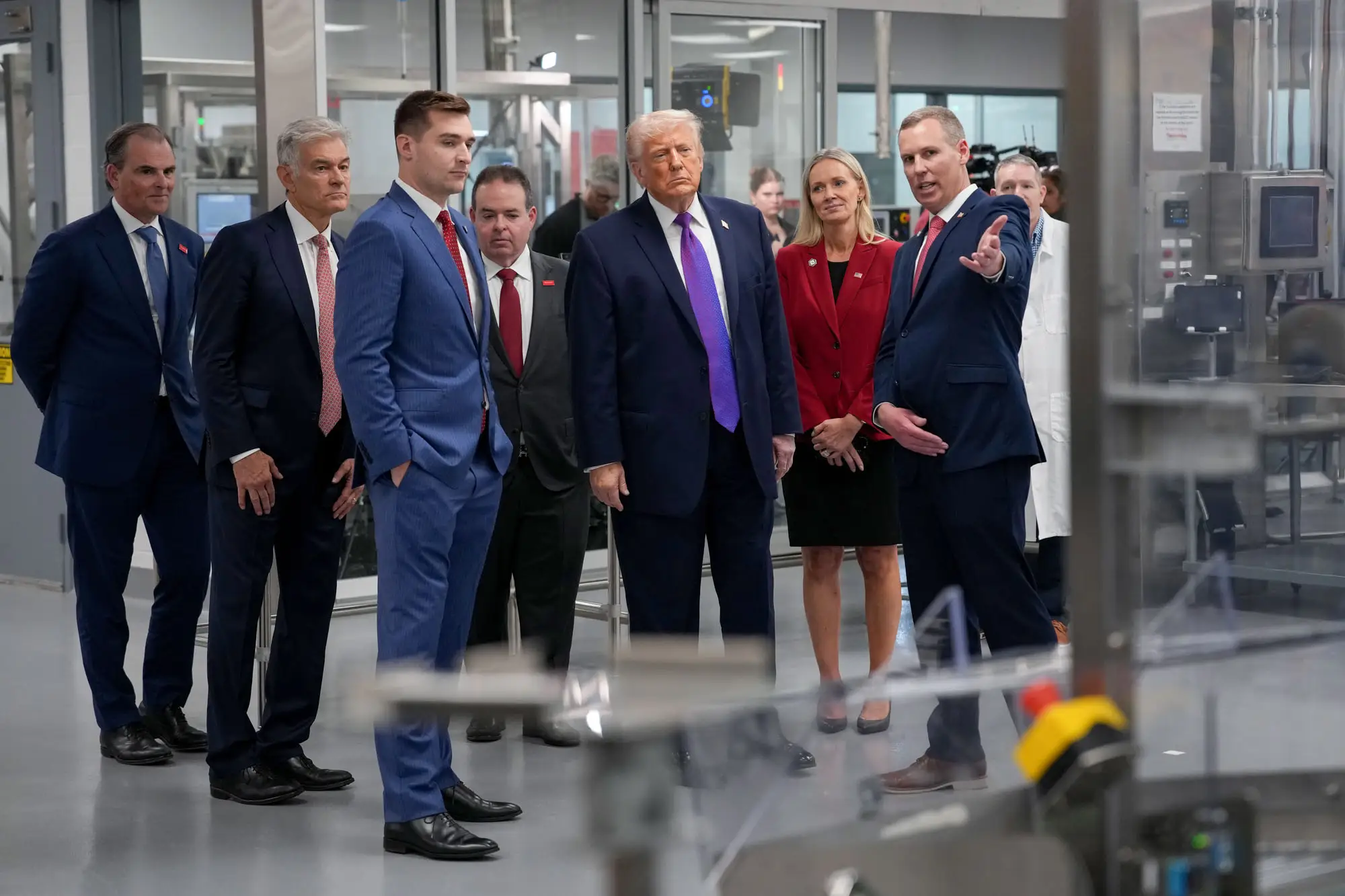 Alex Bruesewitz and Donald Trump tour a Thermo Fisher Scientific facility.