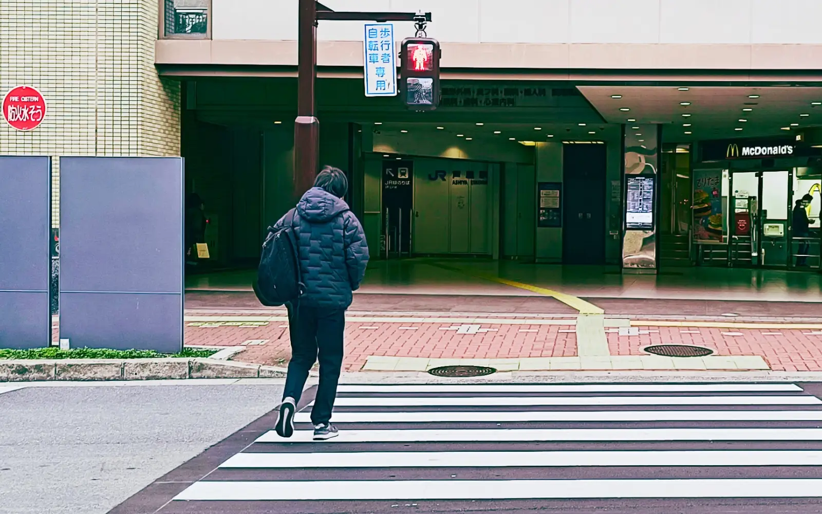 Person crossing the street on a red signal in Japan
