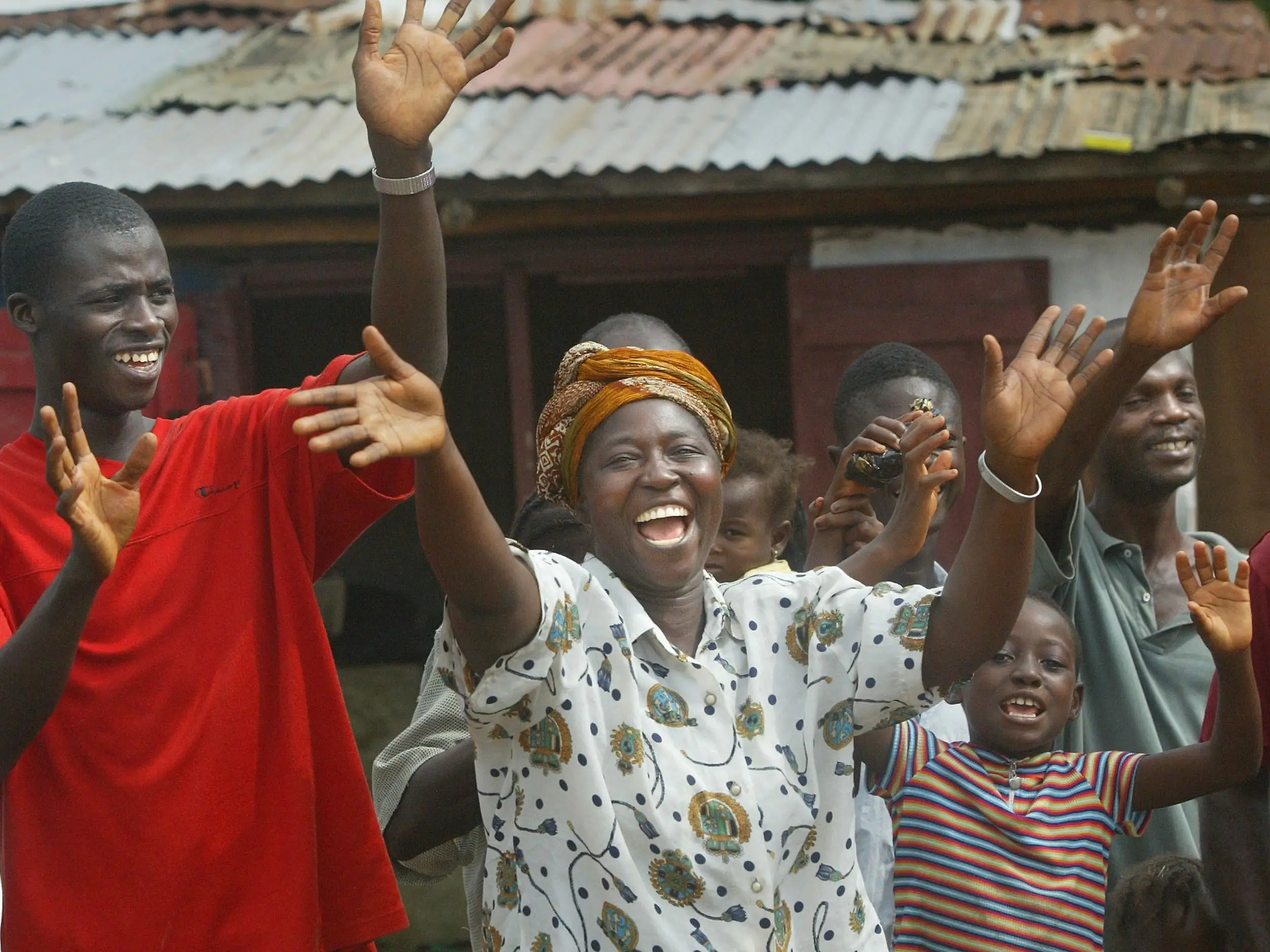 Liberians waving with their arms up.