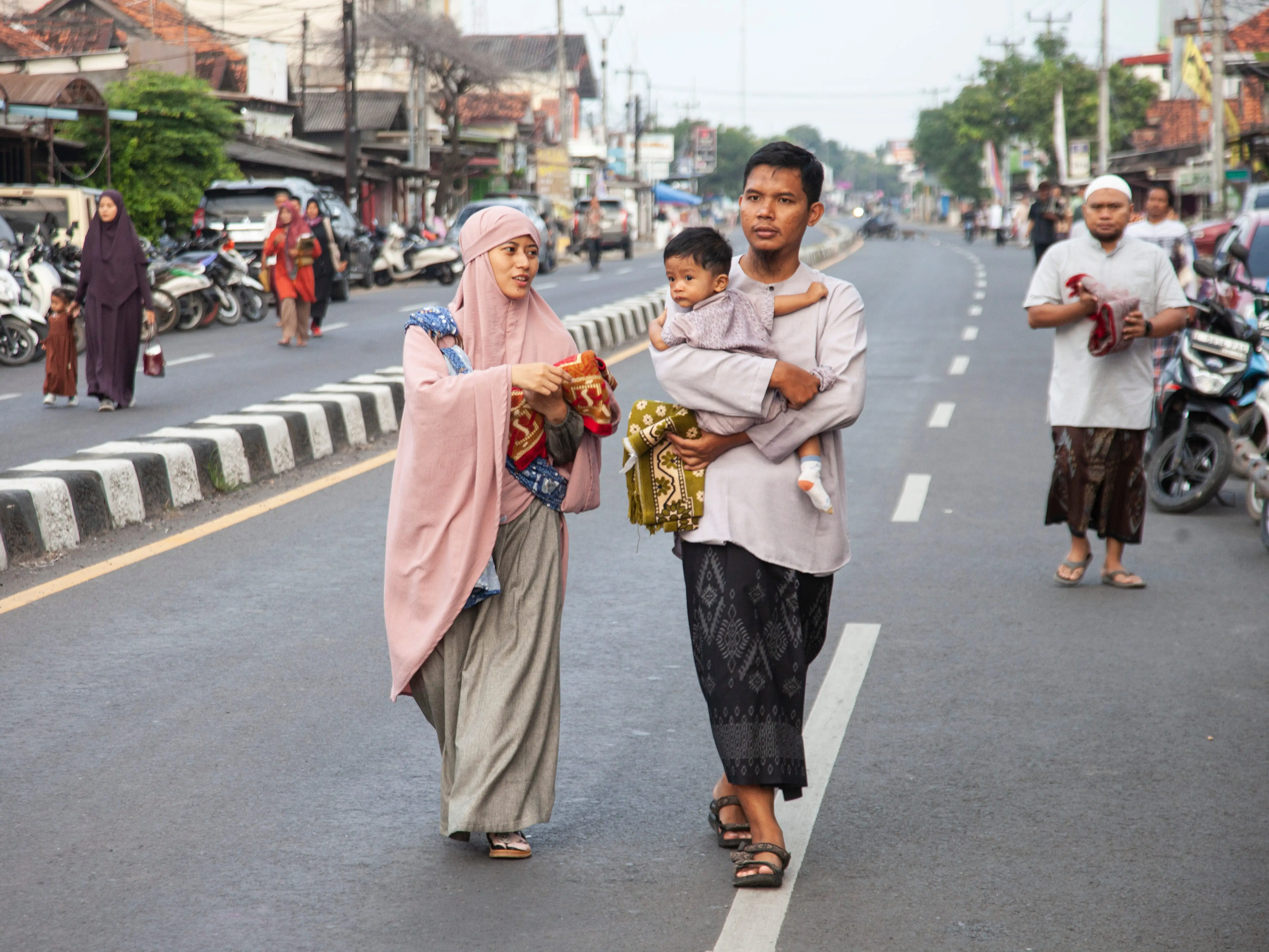 Muslim Indonesians walk towards Babussalam Mosque in West Java province, Indonesia, to offer Eid prayers.