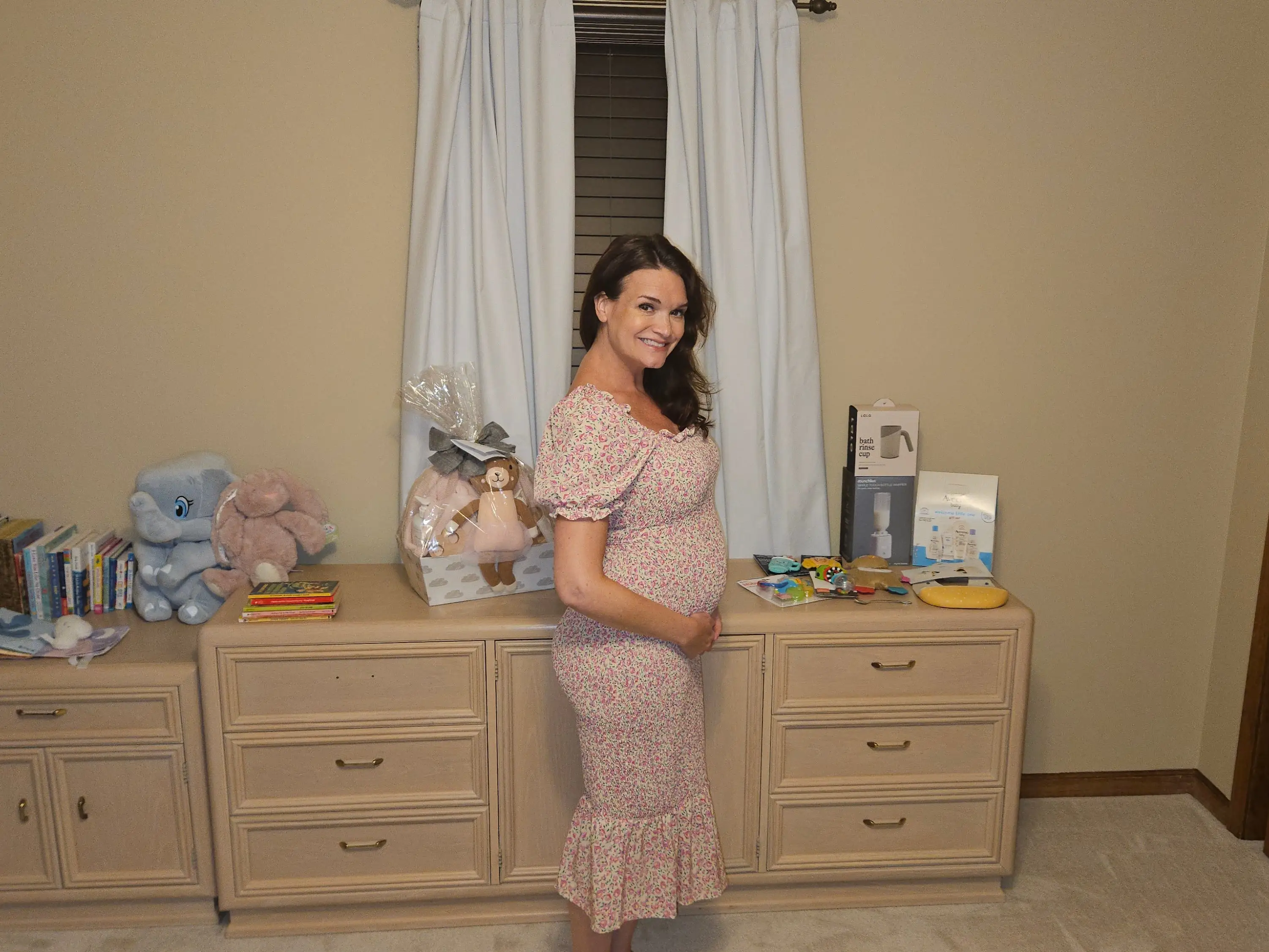 A pregnant woman in a baby's nursery.
