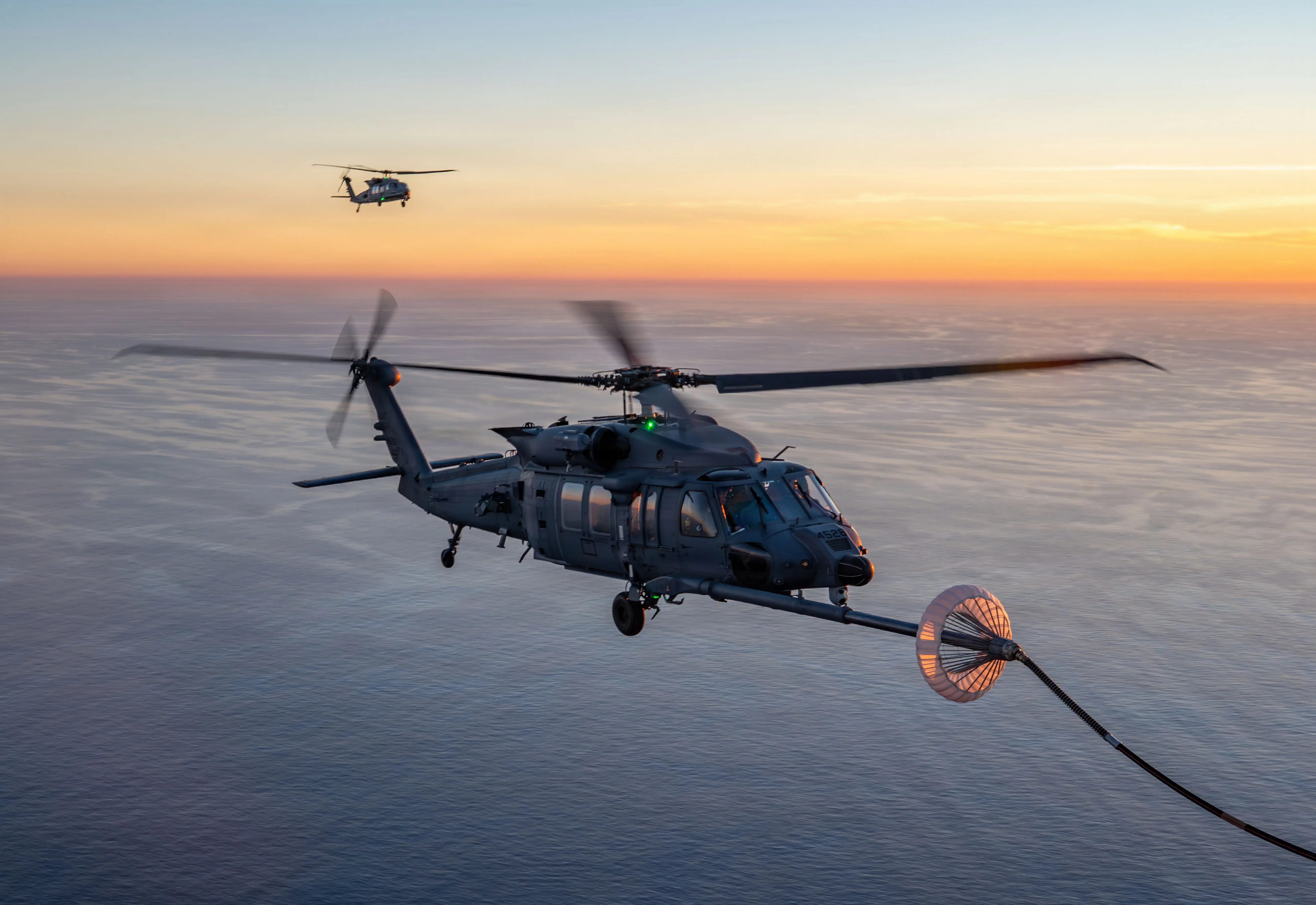 A 305th Rescue Squadron HH-60W Jolly Green II receives fuel from a HC-130J Combat King II off the coast of California during an exercise on Dec. 7, 2025.
