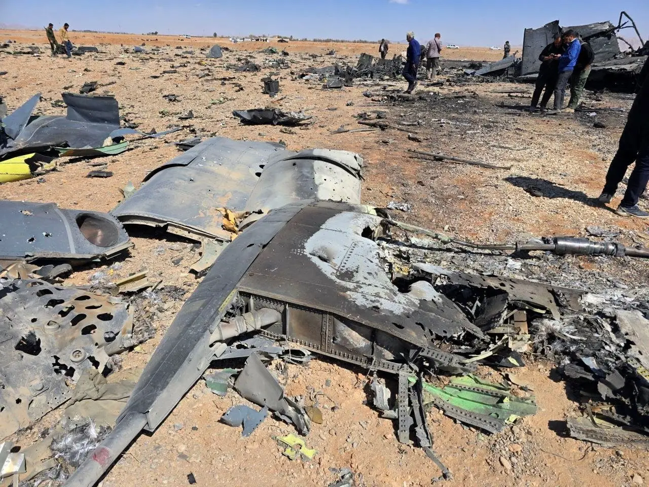 Metal debris lies in the desert.