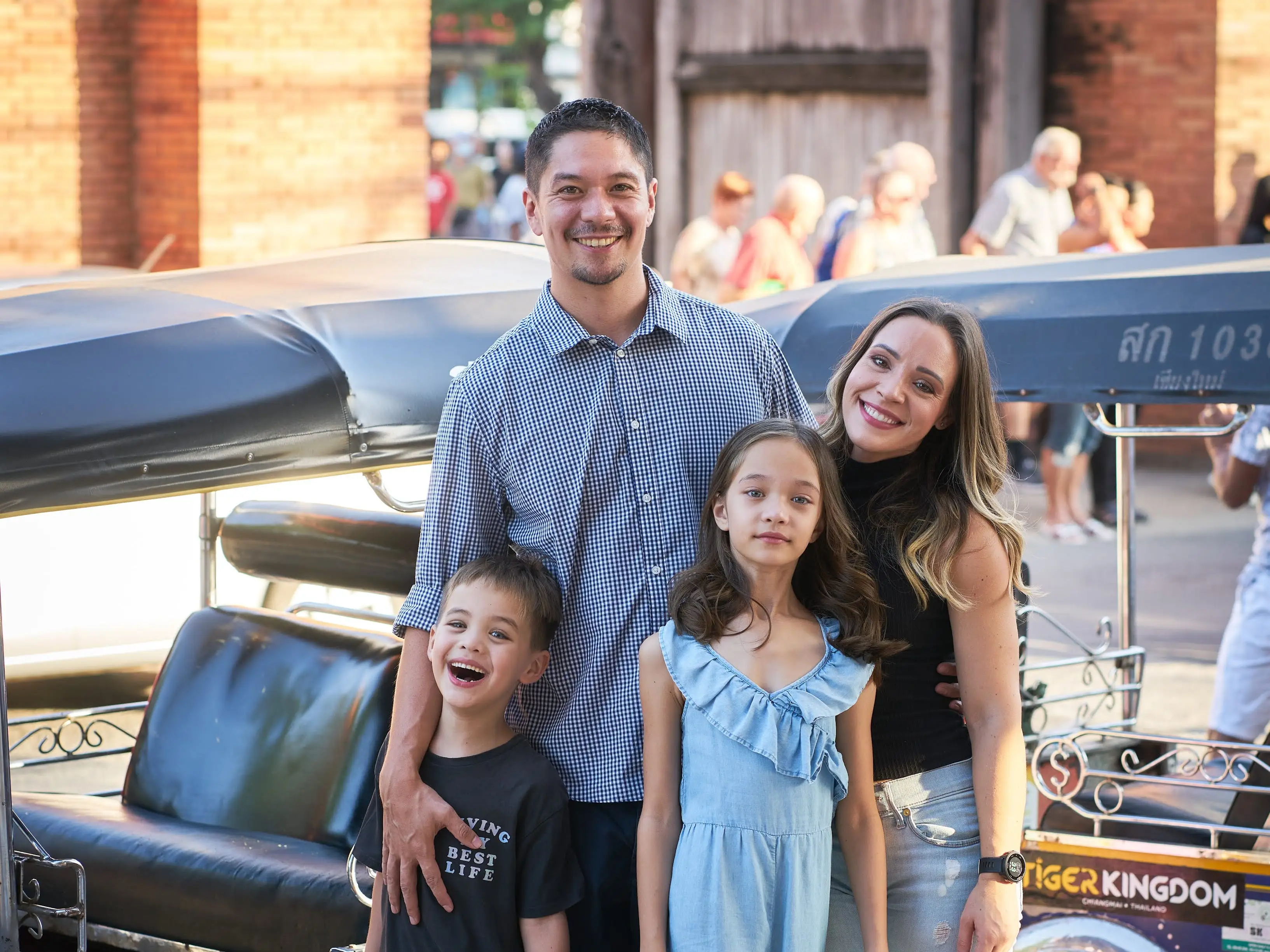 A family posing for a photo in Thailand.