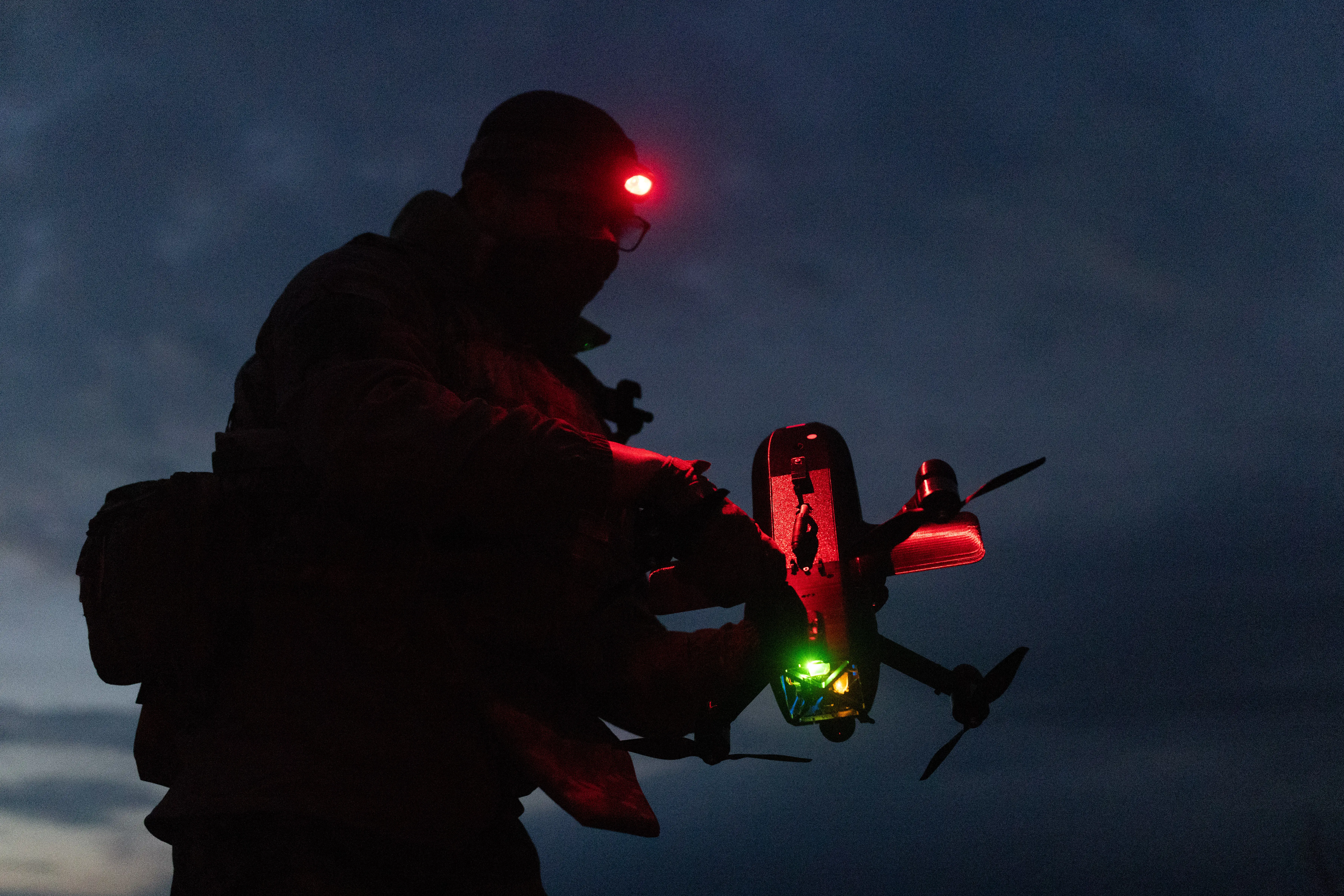 A soldier of the Unmanned Systems Forces prepares a drone 'Salut' for flight by connecting cables to the system on March 31, 2026 in Kharkiv, Ukraine.