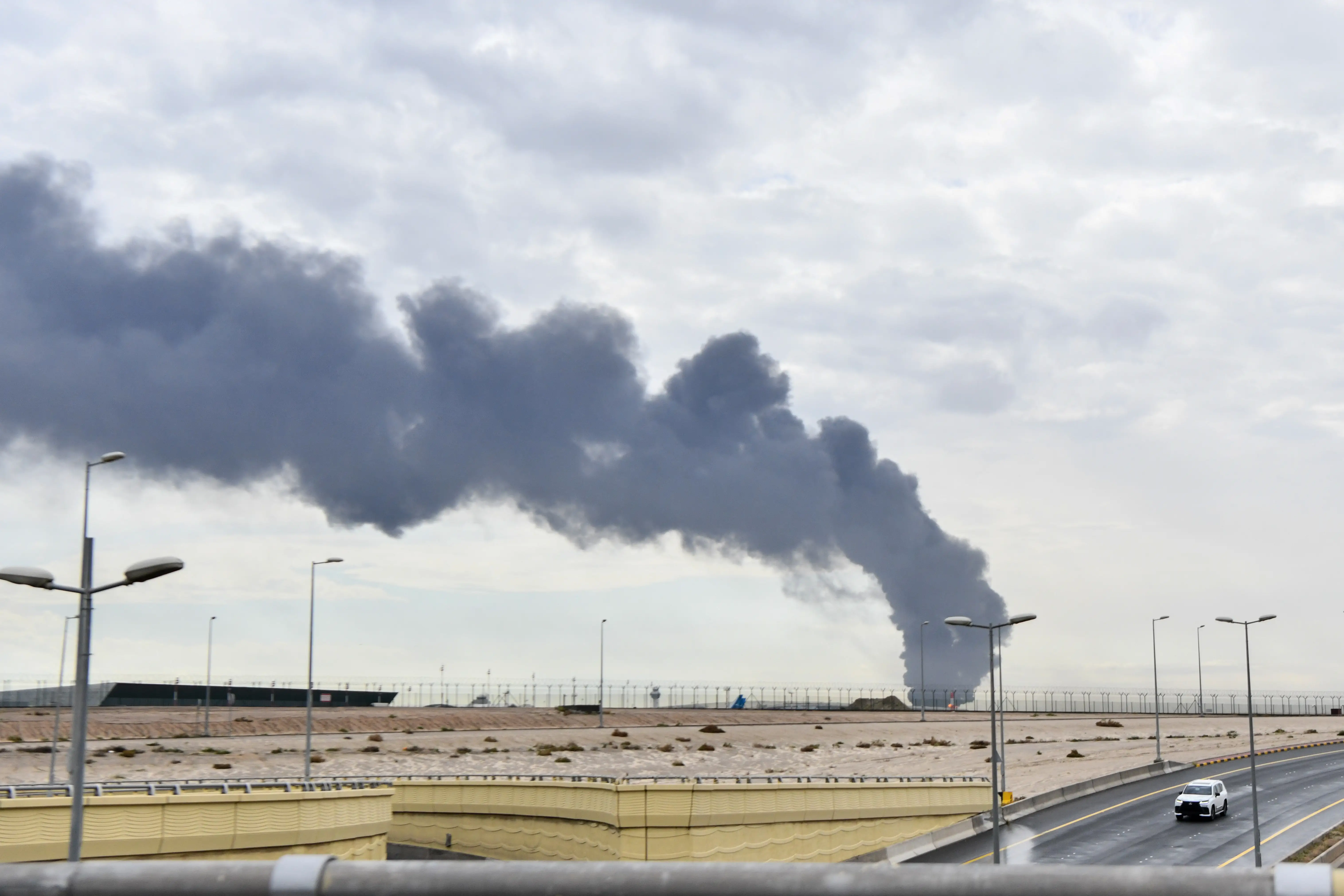 Smoke rises after an Iranian-sourced unmanned aerial vehicle (UAV) carried out an attack on a fuel depot at Kuwait International Airport in Kuwait City, Kuwait, on March 25, 2026.